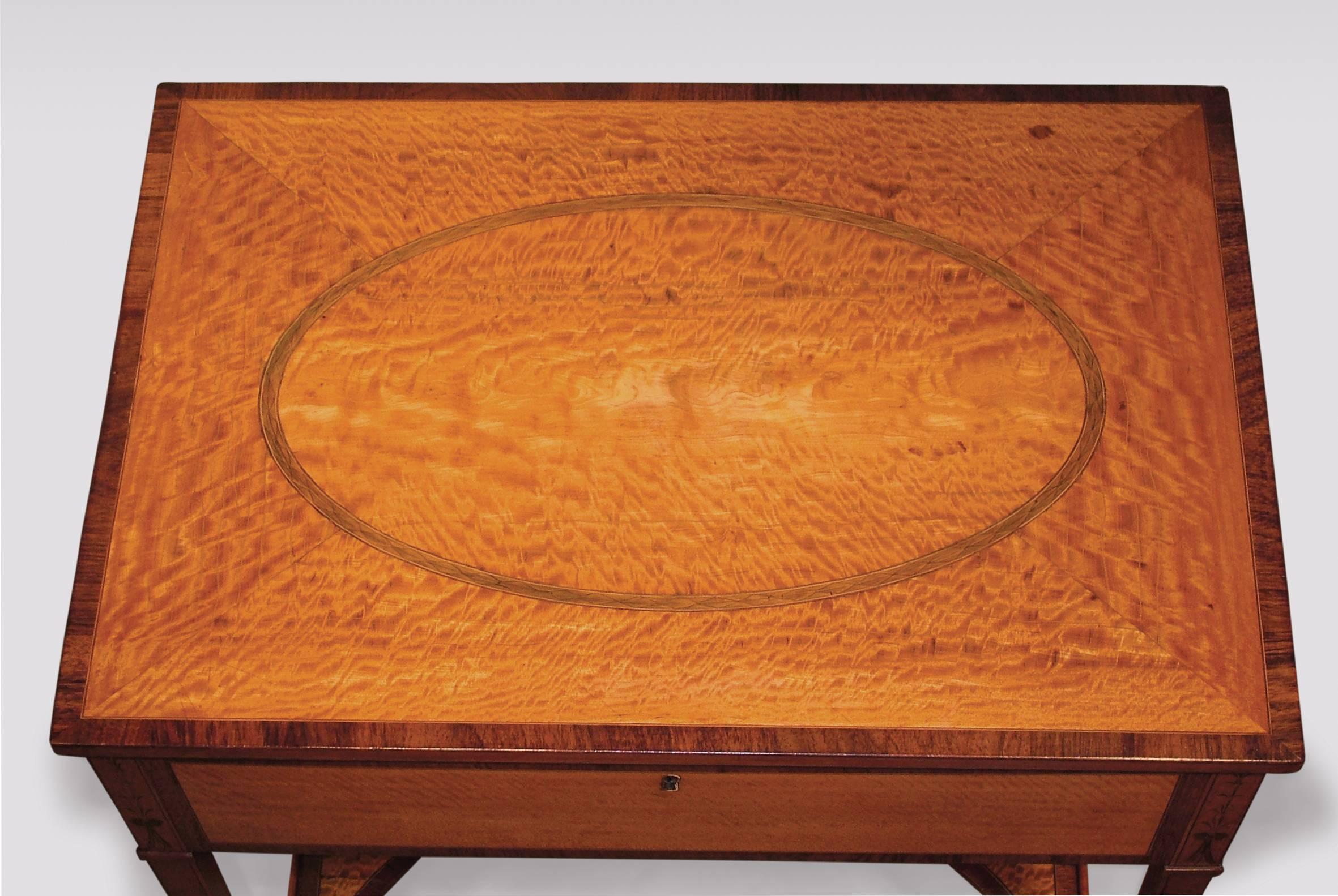 A fine Sheraton period satinwood occasional table rosewood crossbanded and ebony and boxwood strung throughout, having segmented top with central oval panel. The Table, with lift-up top enclosing mirror and various compartments supported on square