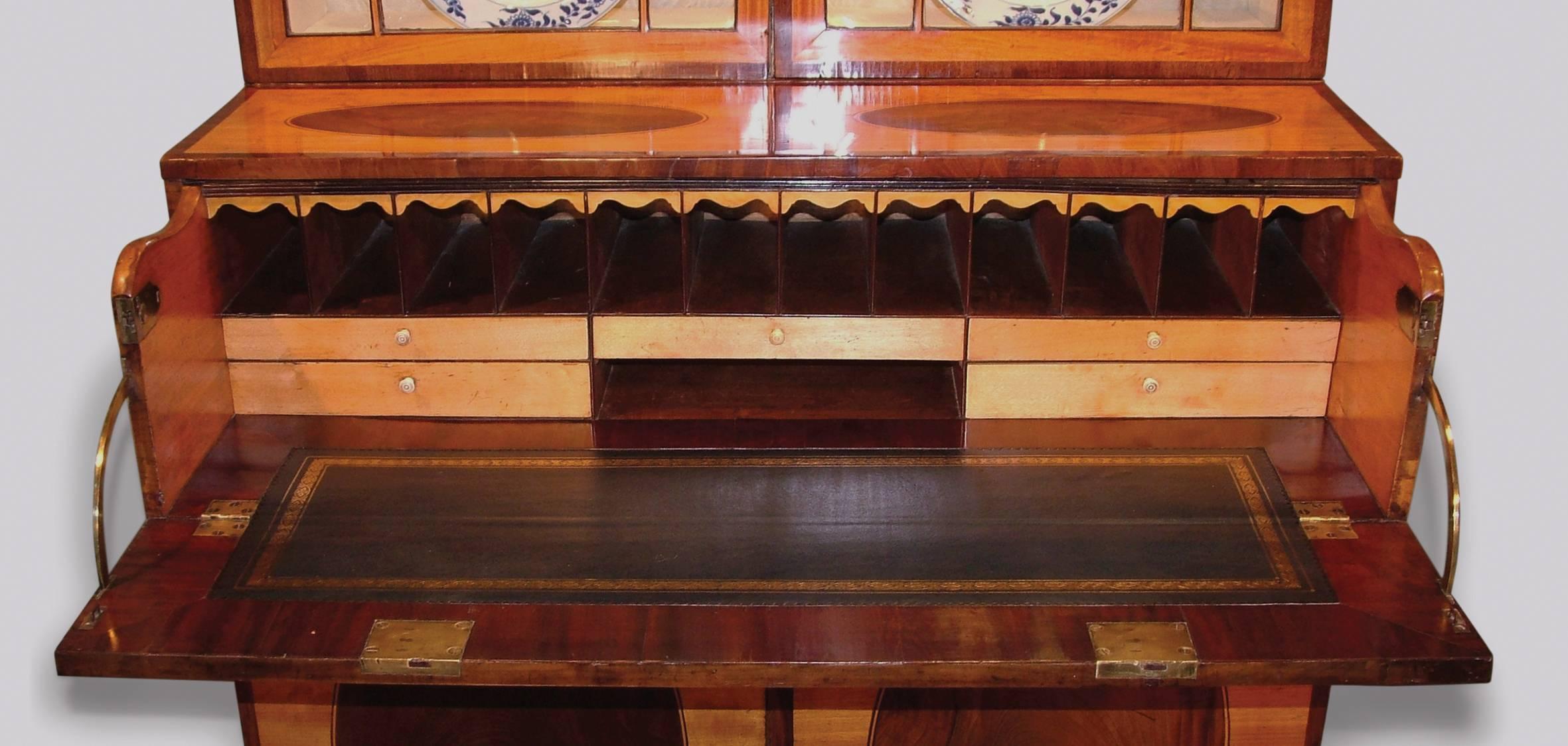 A fine antique late 18th century Sheraton period satinwood secrétaire bookcase, crossbanded throughout and of attractive small proportions, having solid moulded cornice above crossbanded geometric astragal glazed doors. The bookcase having flame