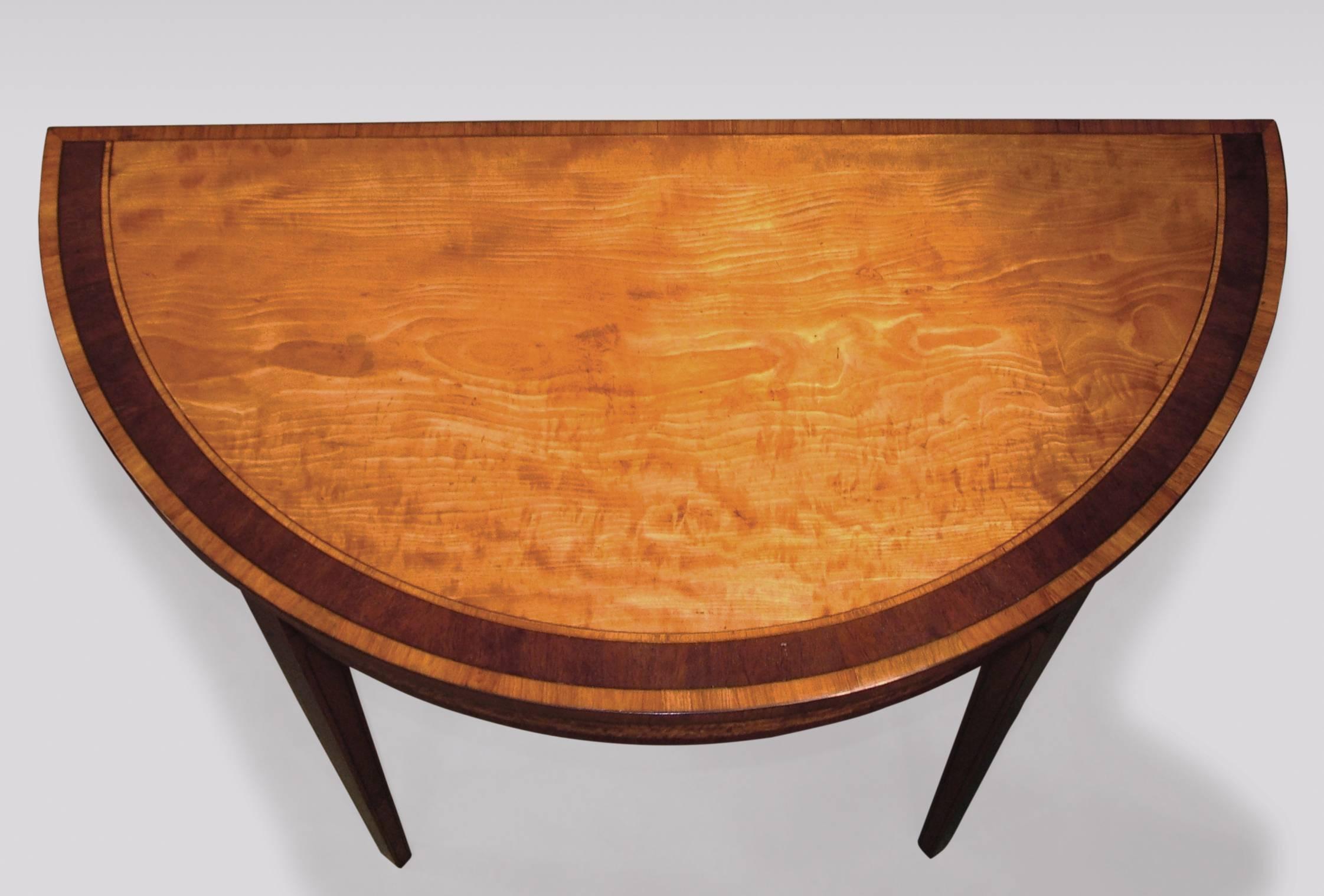 A fine late 18th century Sheraton period figured satinwood half round card table, having tulipwood and purple heart crossbanded top, above ebony line inlaid panel frieze supported on ebony line inlaid square tapering legs.