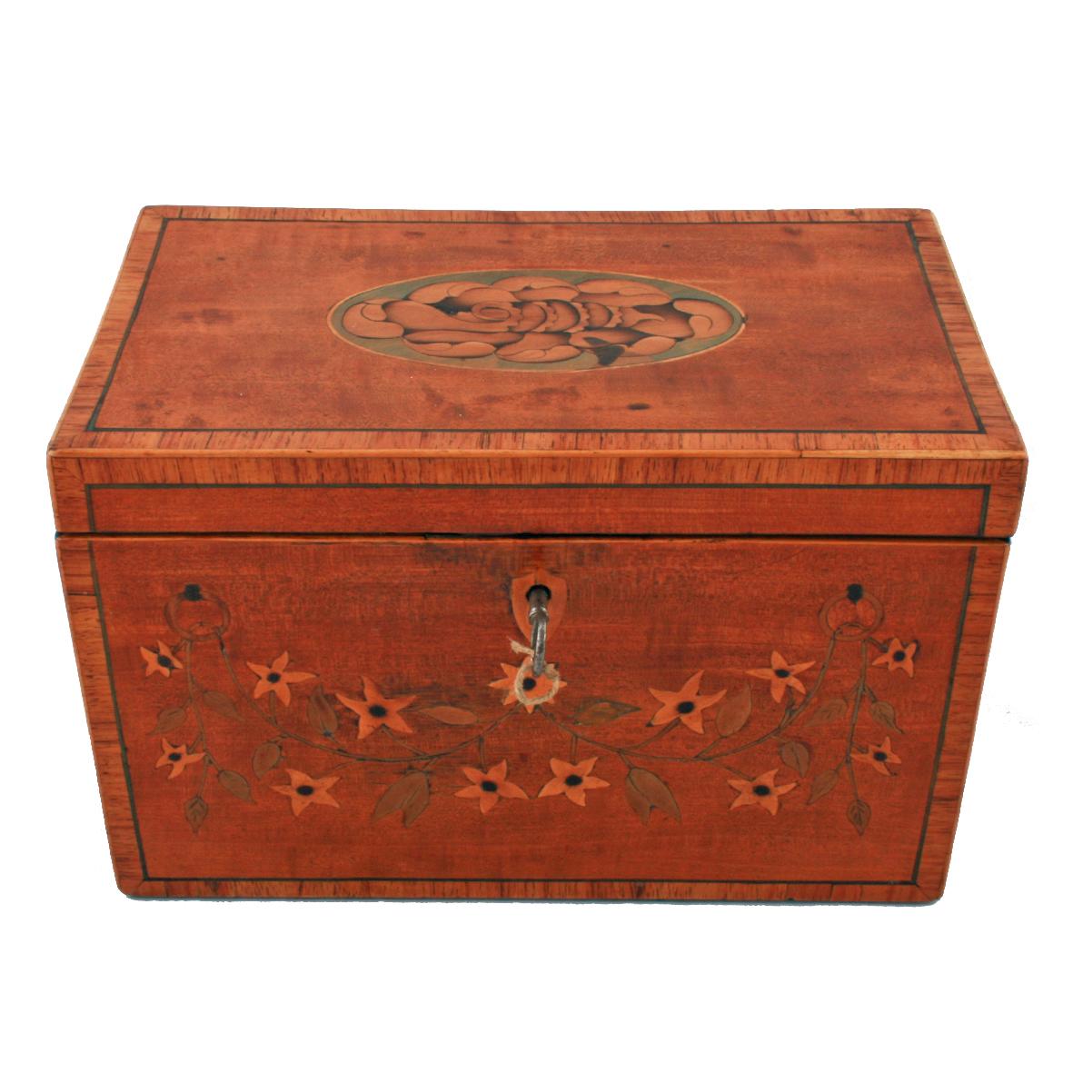 A late 18th century Sheraton satinwood veneered tea caddy.

The tea caddy is kingwood crossbanded edges, ebony line stringing and has marquetry inlay to the top of the lid and front.

The interior has two mahogany lids with brass knob handles
