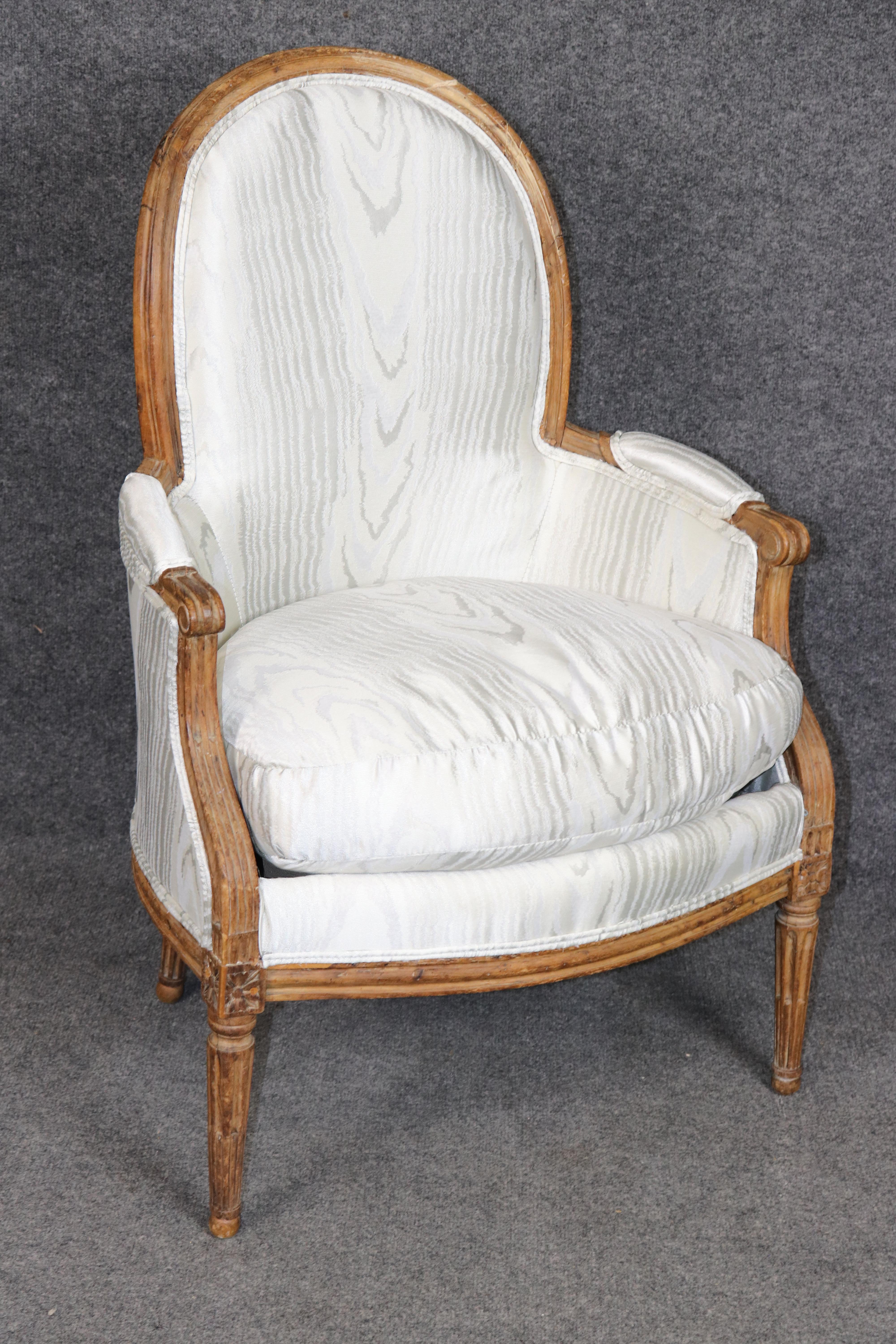Dimensions - H: 37 3/4 in W: 25 1/4 in D: 24 in SH: 19 in 

An exceptional 18th century French Louis XVI carved bergère chair, finely crafted and signed by a distinguished Parisian menuisier. While the signature is faint and stamped multiple times