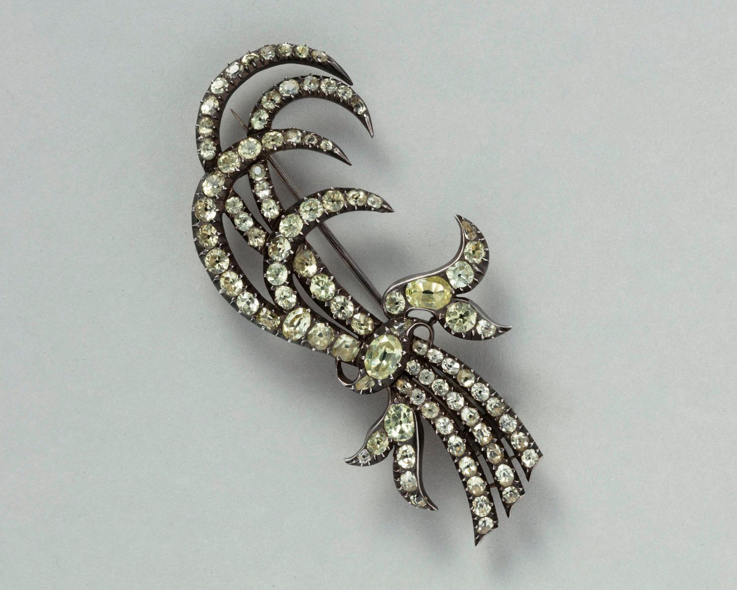 A large aigrette - turned into brooch - of chrysoberyls set in silver (gold backing) in the form of a spray of four feathers bound together by a ribbon, Portugal, end 18th century.

An aigrette, in jewelry, is so-called because of its resemblance to