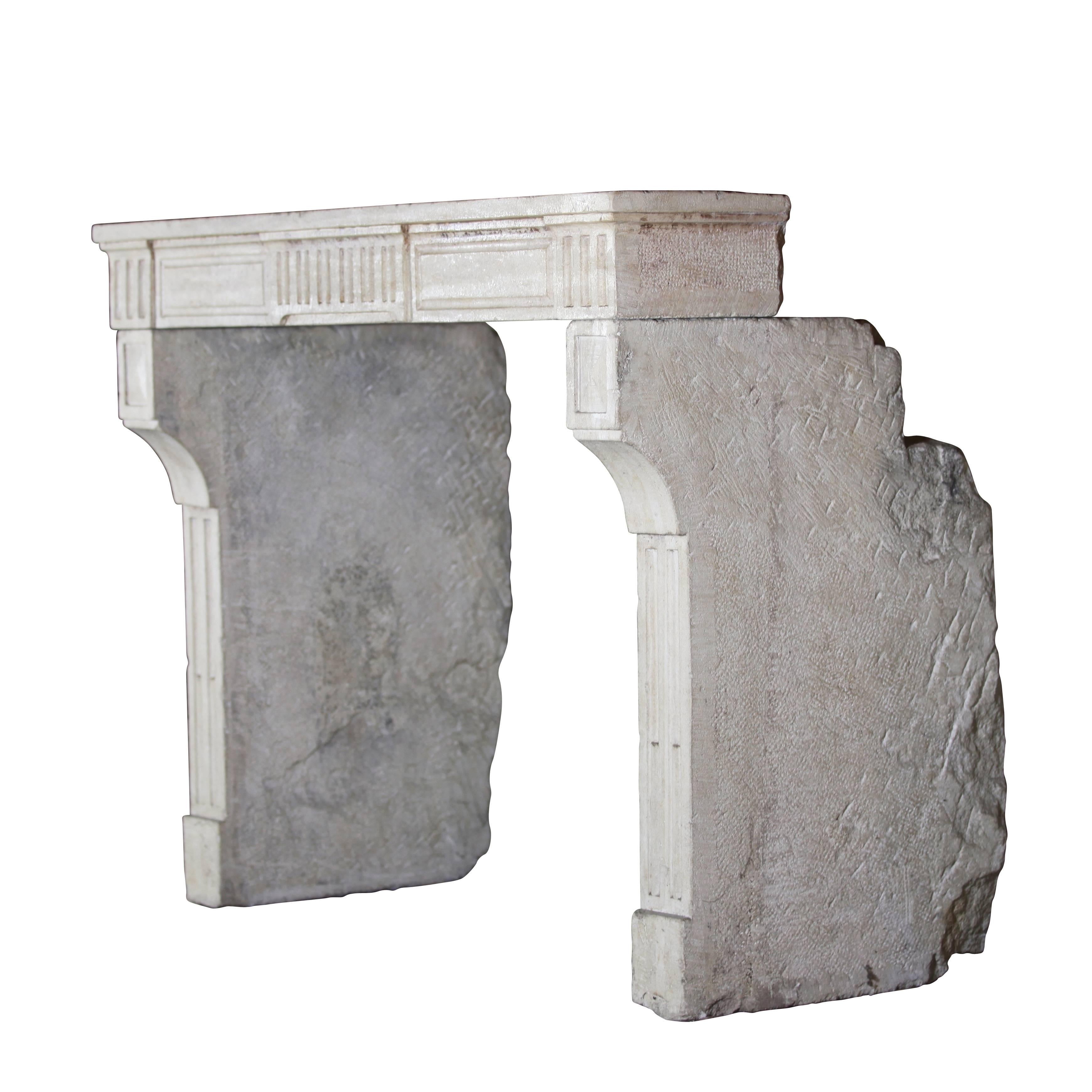 Beautiful French country petite fireplace mantel (fireplace) in limestone with diamond point detail on the jambs. The limestone is the kind that reflects the candle light and lamp light in a room thanks to its glossy ancient surface. It has very