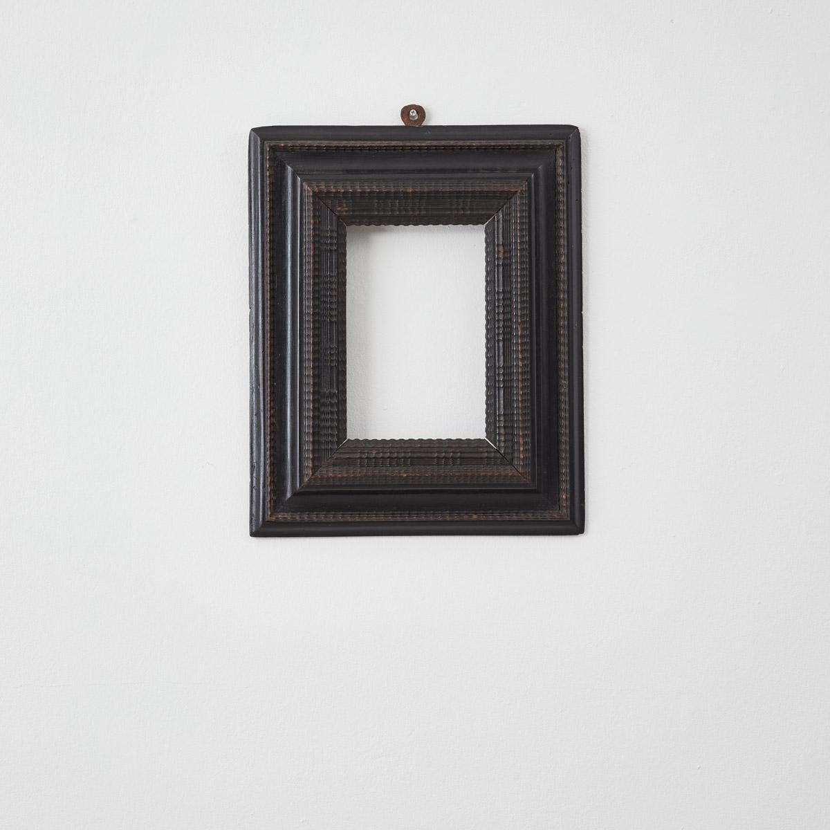 Made in Italy over two hundred years ago, this striking ebonised wooden ripple frame is made in the 17th Century Dutch ripple style. Its surface is intricately detailed and engraved with the carved ripple patterns.