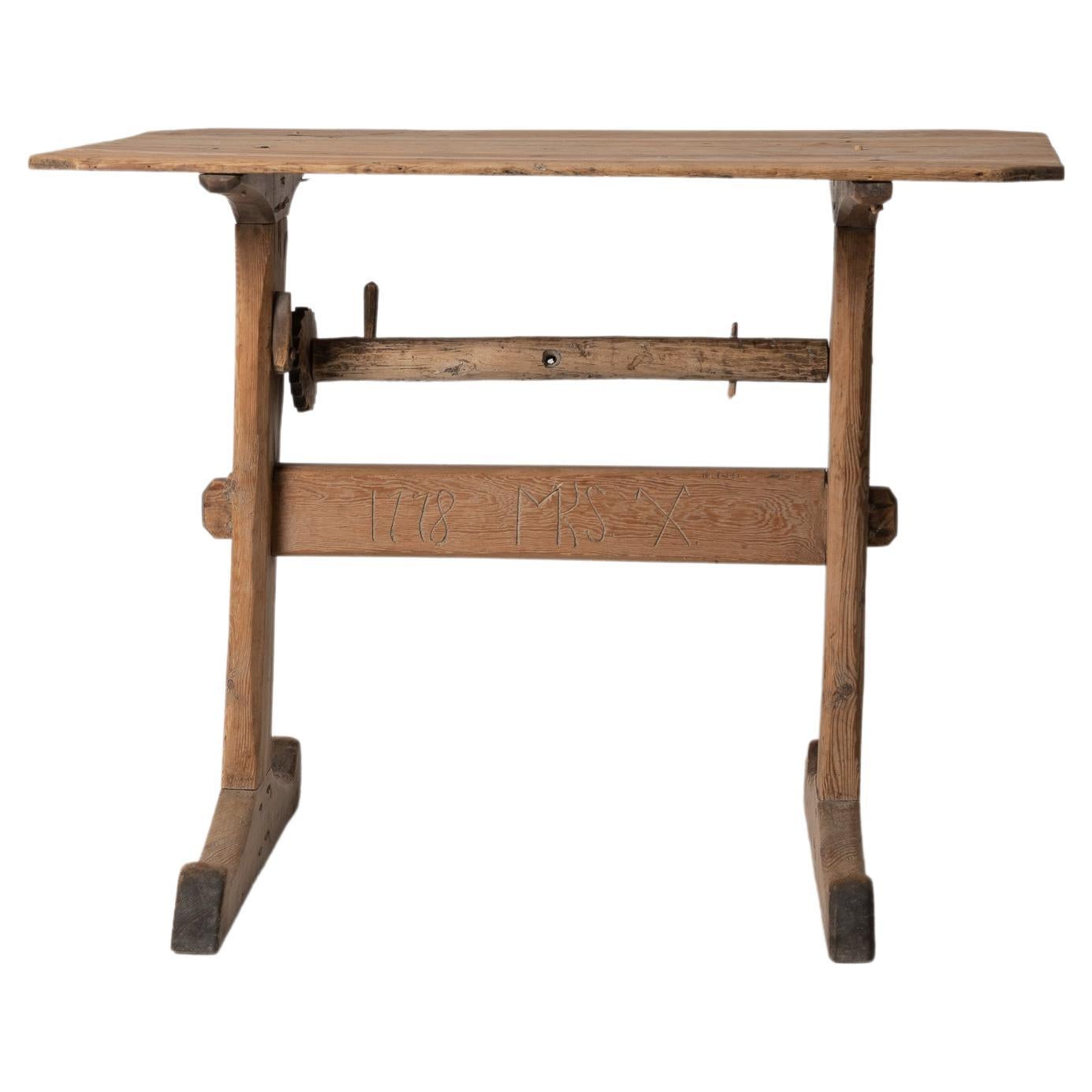 Small Swedish folk art table from northern Sweden with a hand carved year 1778, initials and house mark. The table is a charming folk art furniture with a simple construction and patina of time. It’s unusual to see dating and markings on these kinds