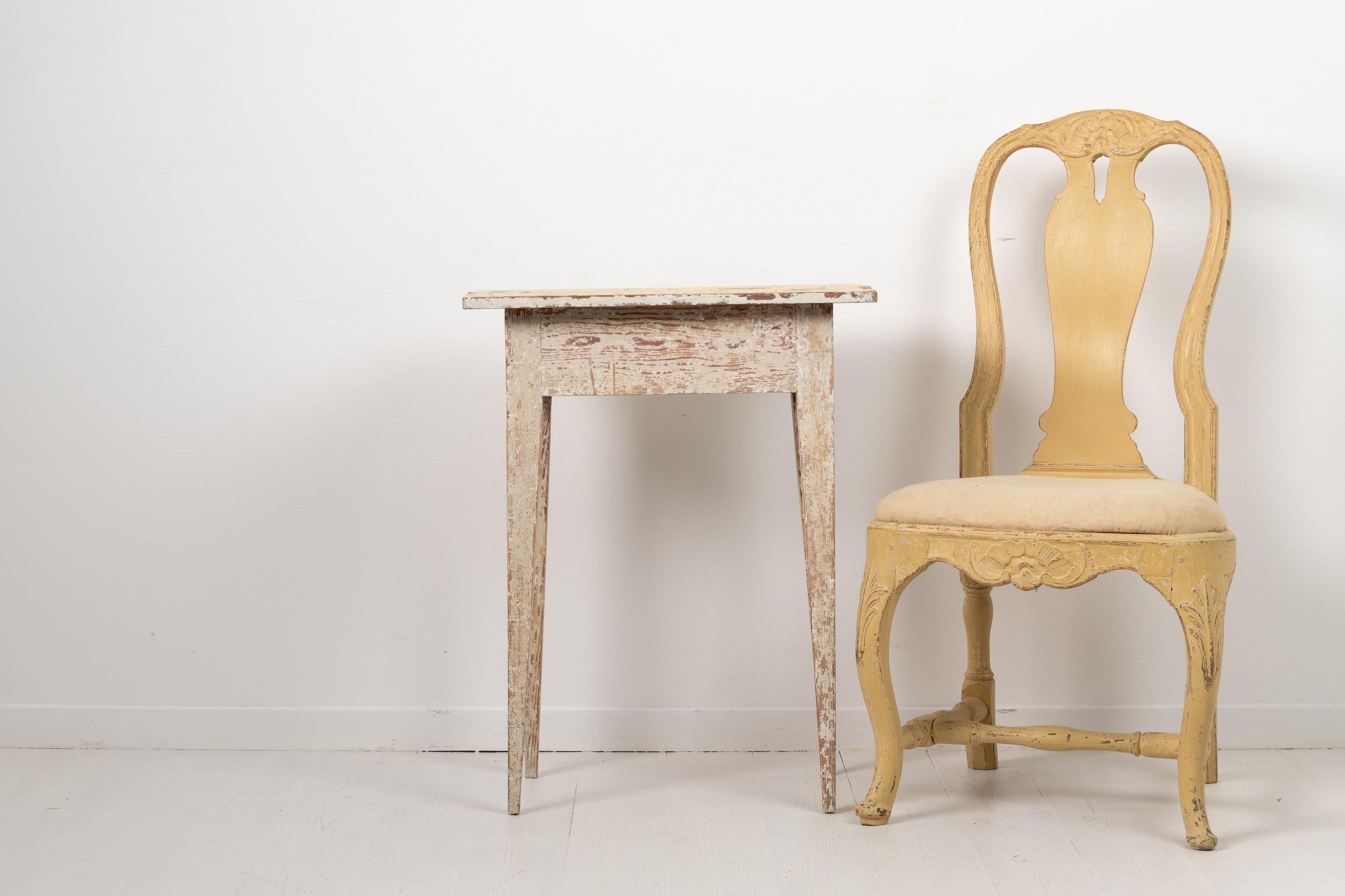 Swedish side table from the gustavian period made around 1790. The table is Swedish pine with a rectangular table top and straight tapered legs. Dry scraped by hand to the first and original layer of paint. The table has a rustic and patinated