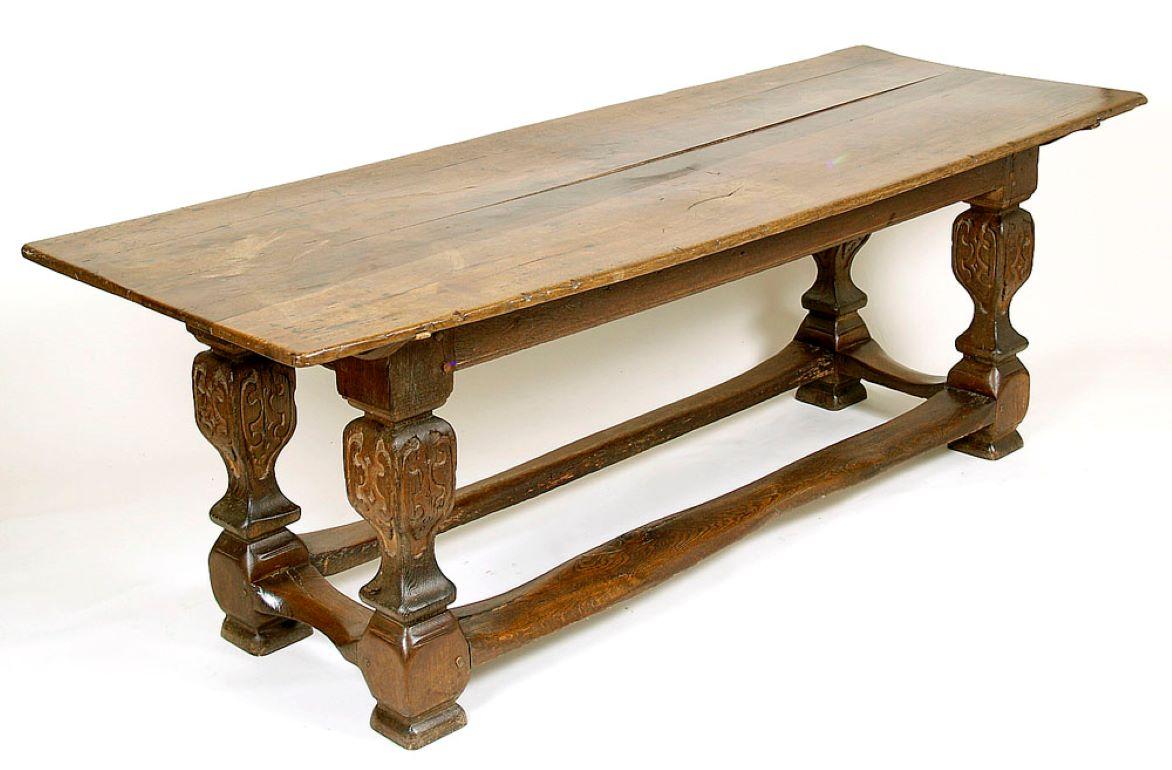 18th century solid oak Baroque refectory table
A Baroque refectory table with an elongated, rectangular top, supported by four massive legs connected by joints. The top consists of three boards, joined together at the bottom by transverse beams