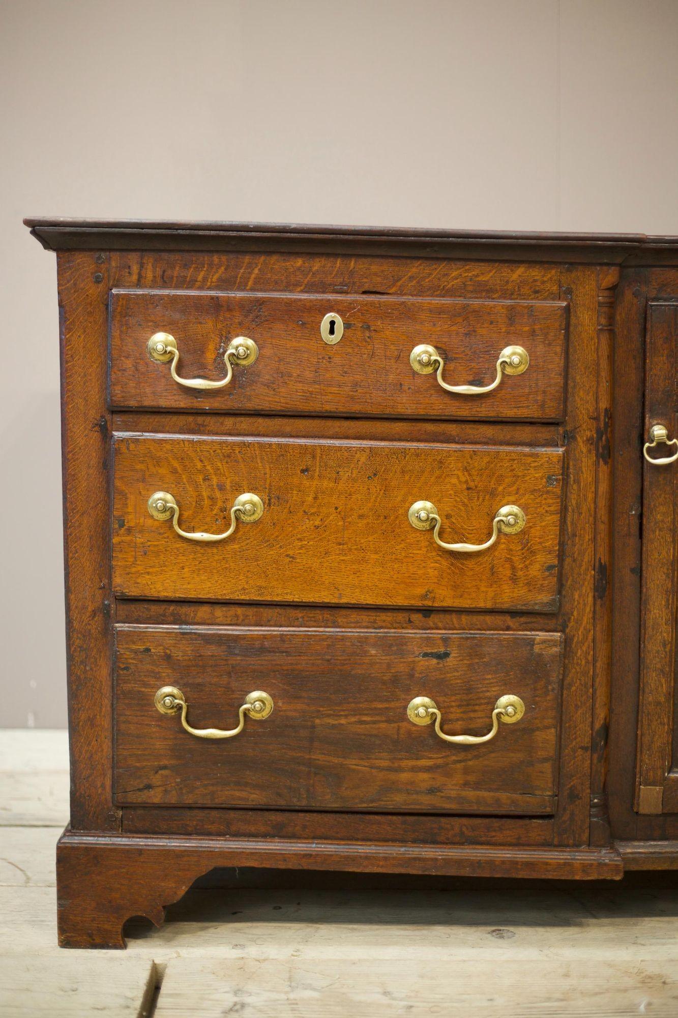 This is a very nice genuine 18th century dresser base. Made from solid oak and full of character. The overall condition is very good with patina consistent with age and use. The drawers all open smoothly and shut flush. Some of the drawers have had