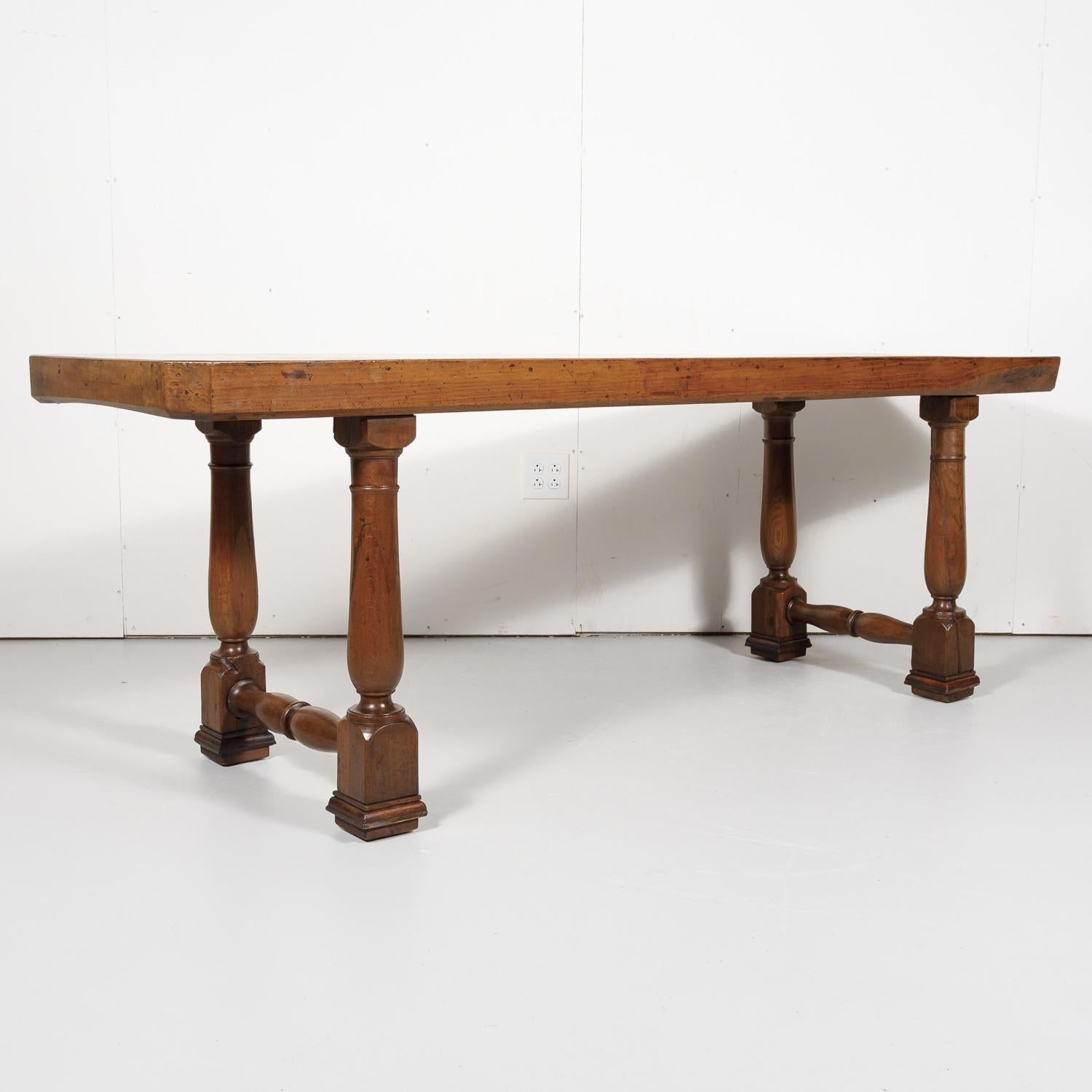 18th century provincial console or dining table handcrafted near Arles of solid old growth French walnut having a rectangular top with canted corners, circa 1770s. The 3.5
