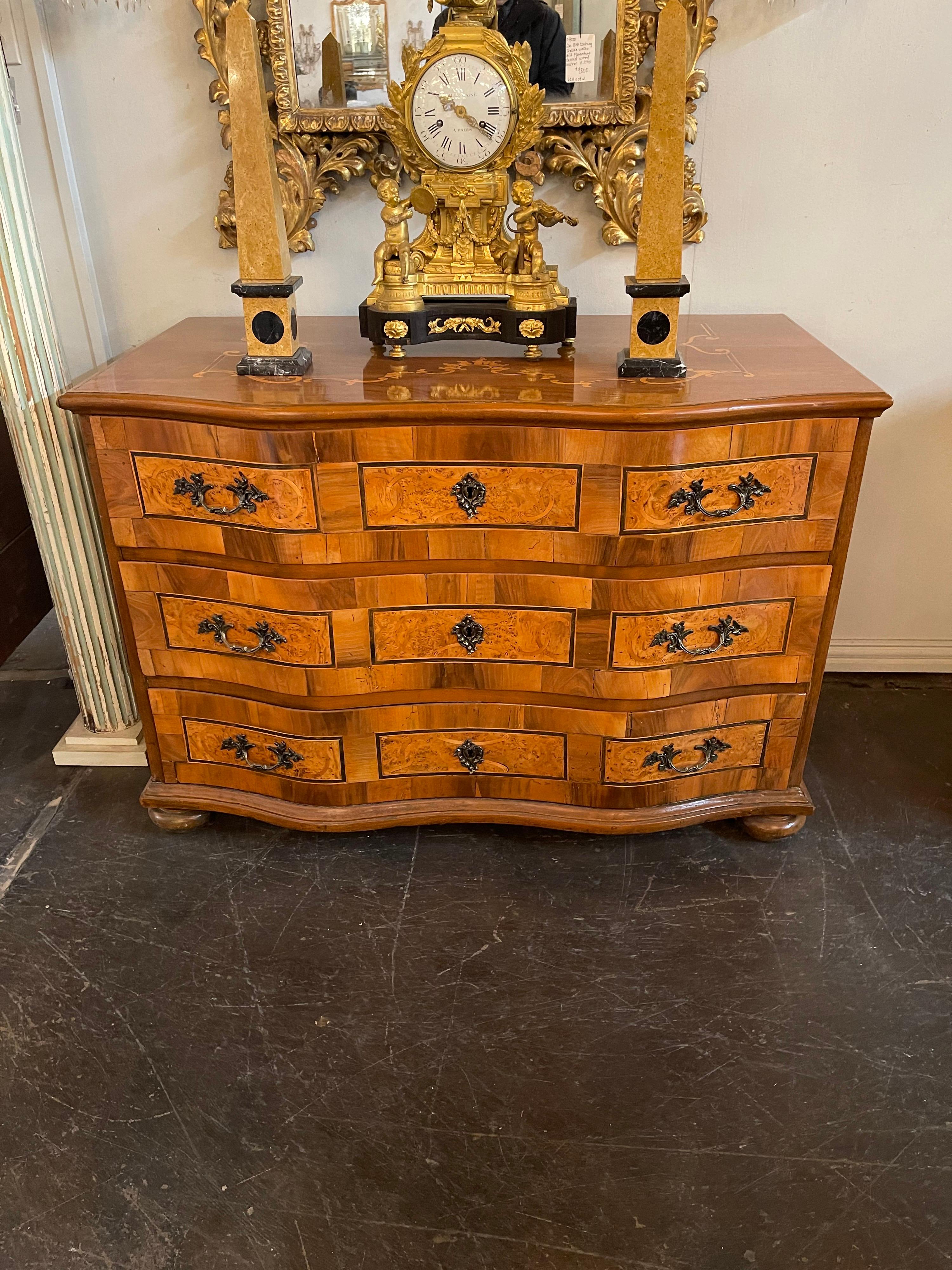 Remarkable 18th century South German (possibly Bavaria) shaped-front commode. The marquetry inlaid double serpentine top above three fitted drawers with outstanding walnut veneer and exotic oak panels that are banded with a narrow strip of inlaid