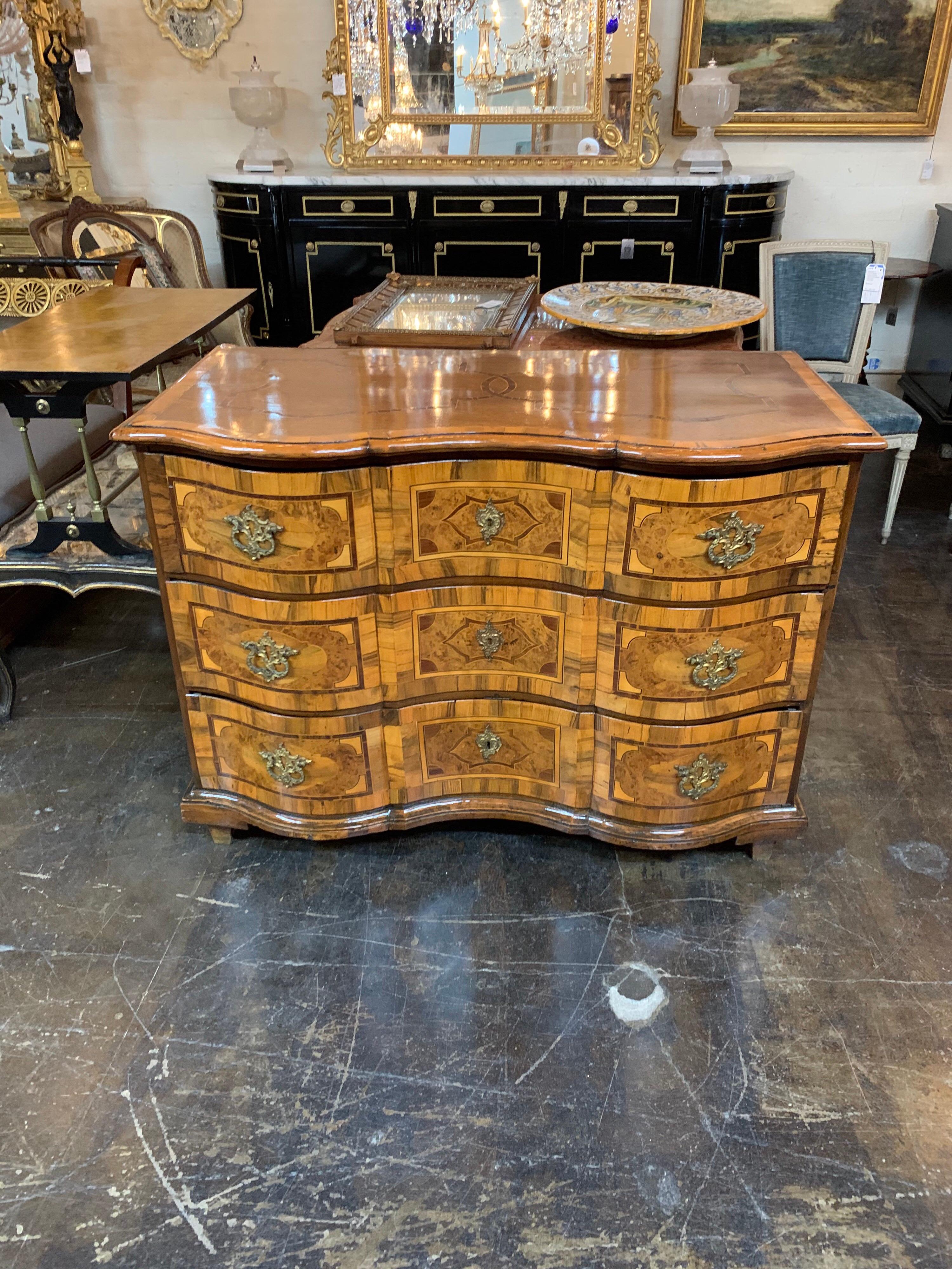 Exceptional south German serpentine shaped commode with gorgeous inlaid wood. A truly elegant piece for a fine home!