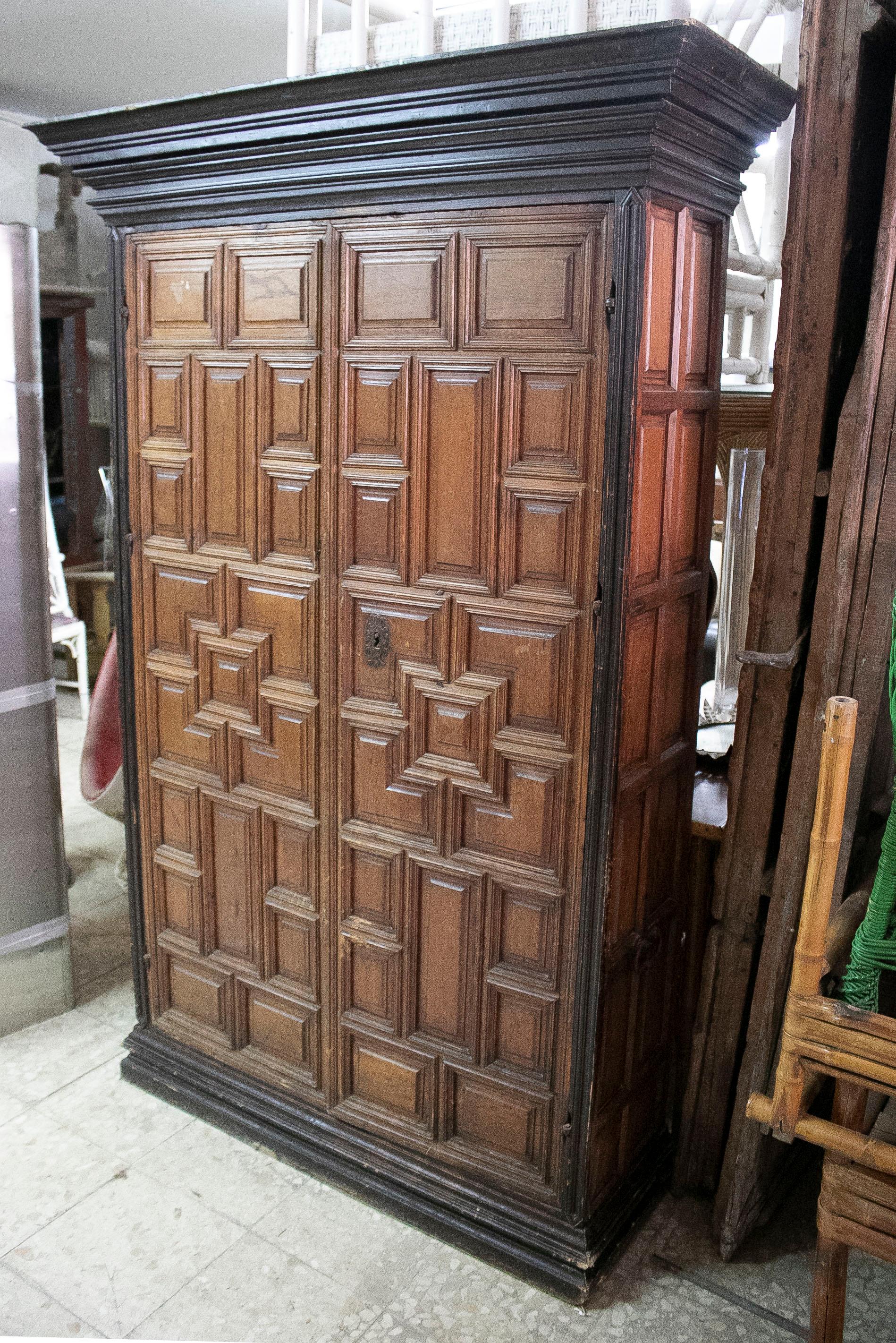 18th century Spanish 2-door cupboard cabinet with raised panels ornamentation and a 3-drawer and 5-shelf interior.