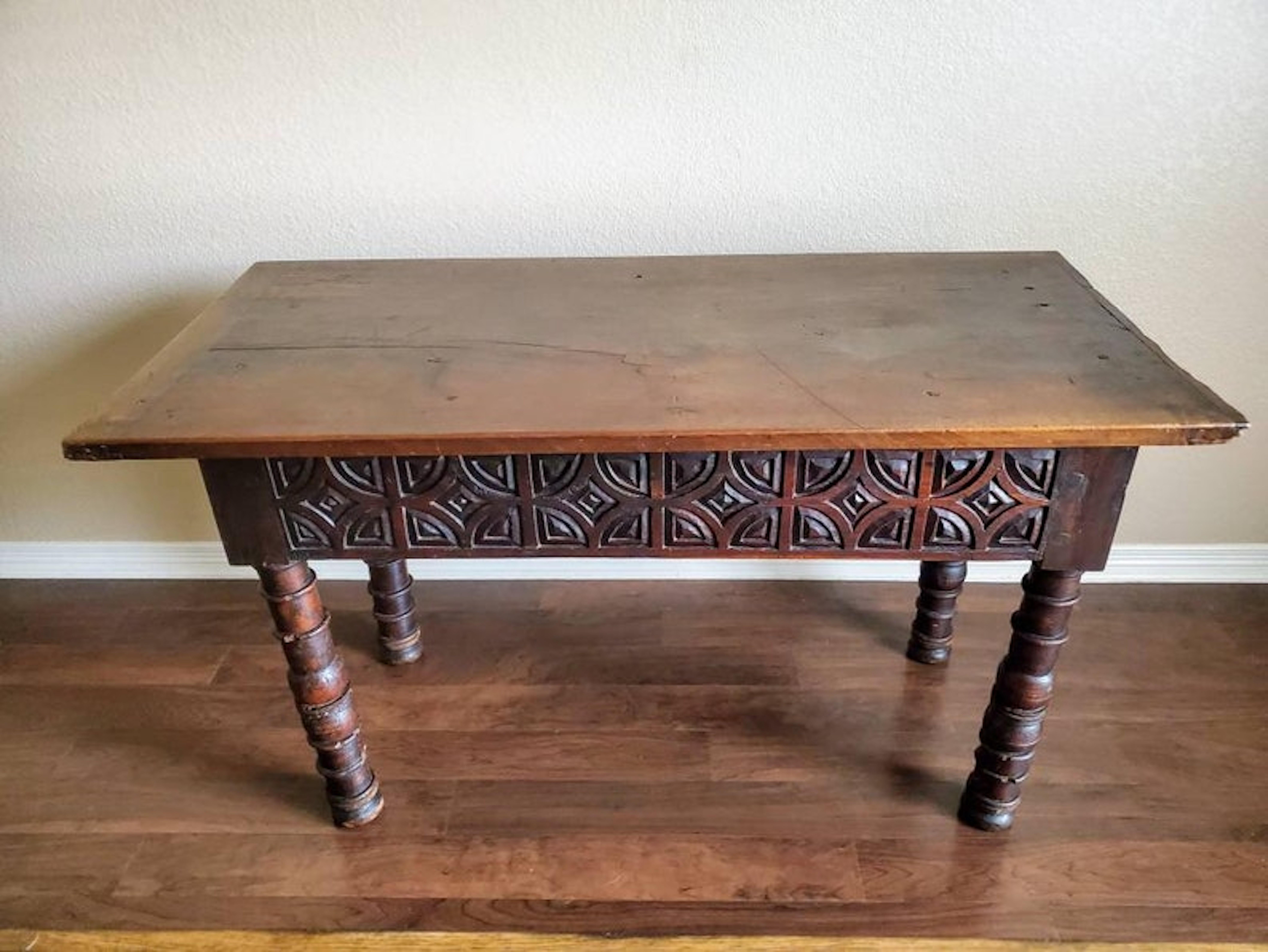 A remarkable one-of-a-kind Spanish Baroque Period hand carved walnut table with beautifully aged warm rustic distressed patina. 

Hand-crafted in Spain in the first half of the 18th century, with later architectural elements, having a rectangular