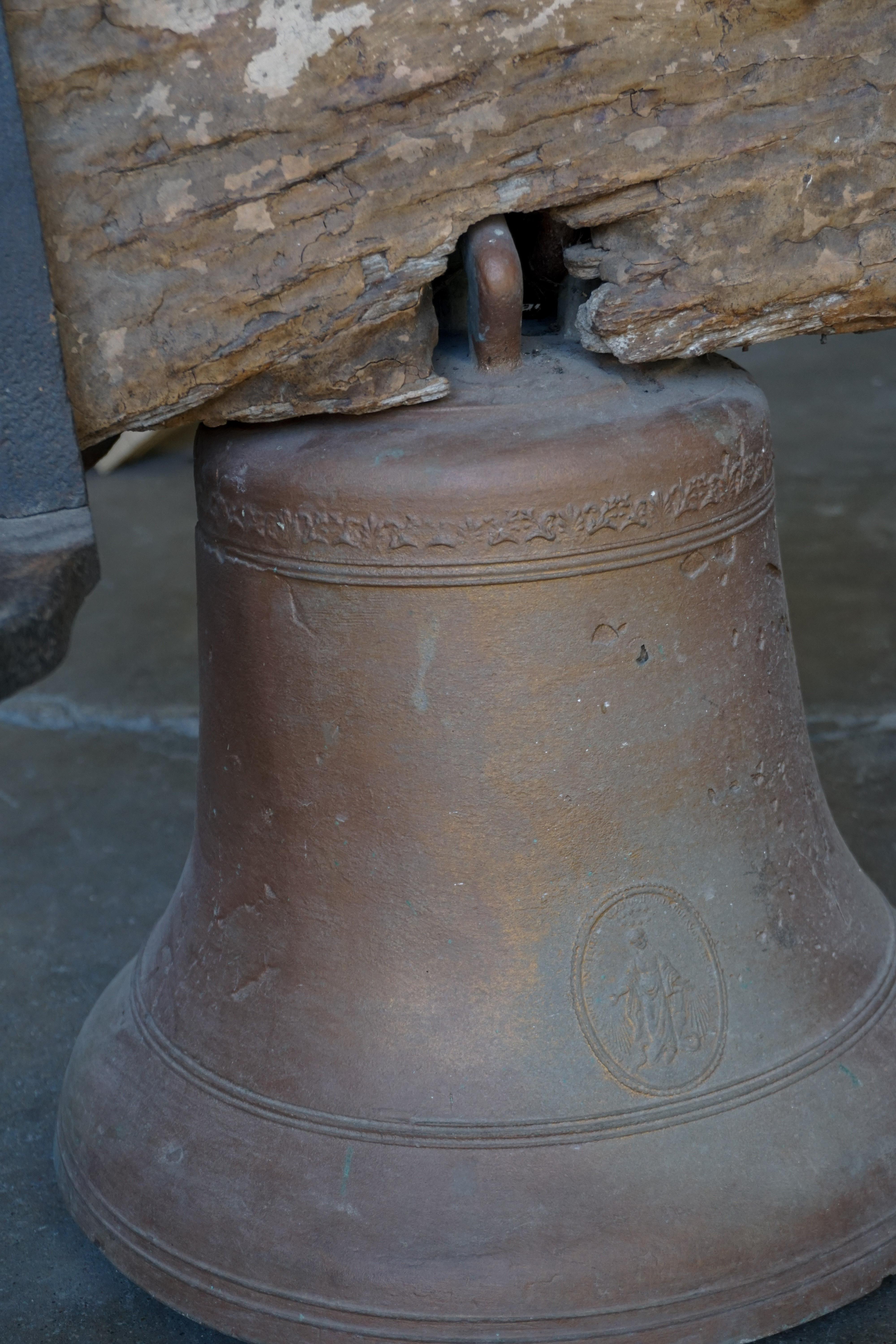 A beautiful antique piece, this bell originates from Spain, circa1700s.

Measurements: Bell alone 14'' D x 14'' H Bell w/ arm 24.5'' D x 23.5'' H.