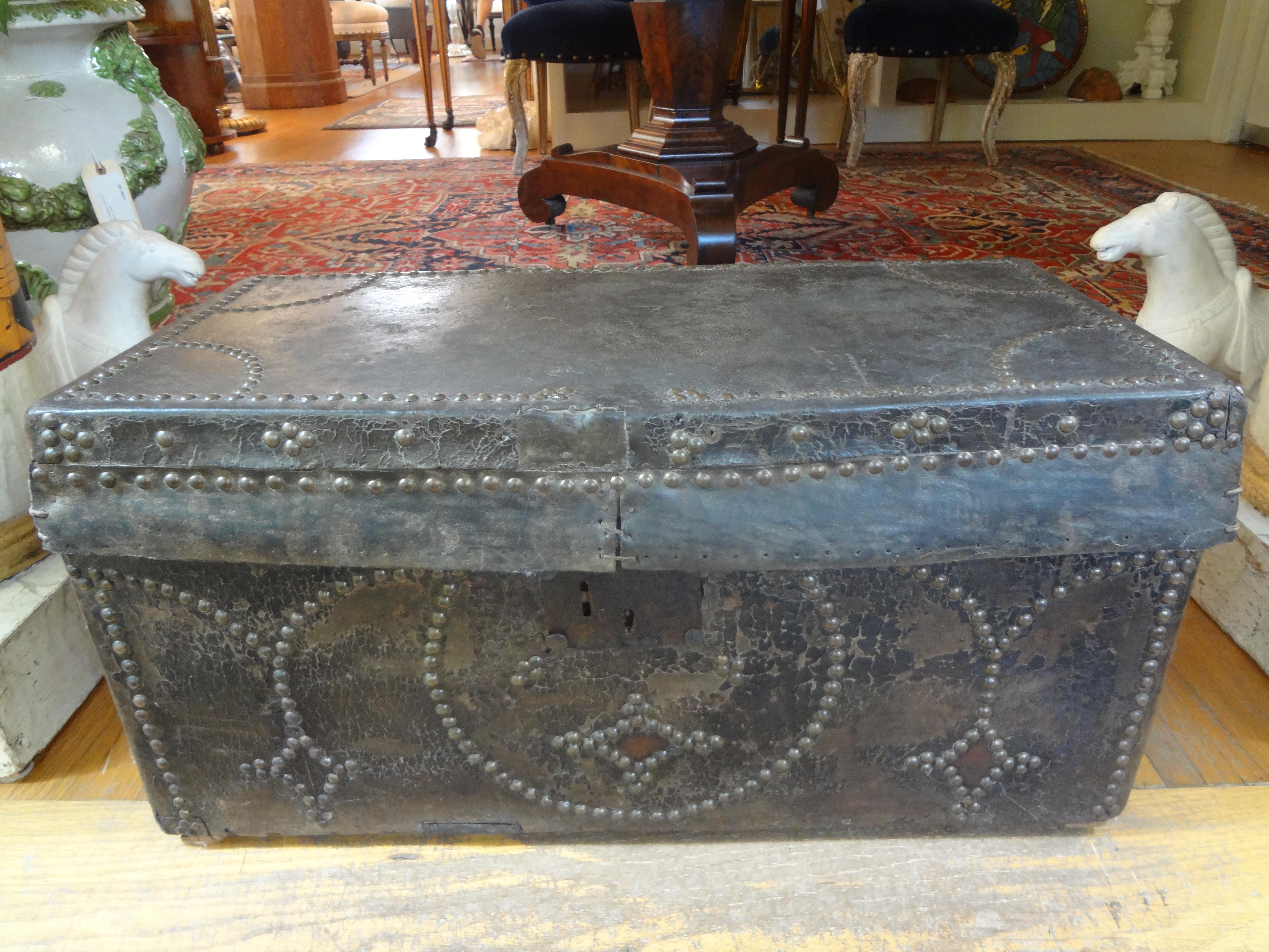 Handsome 18th century Spanish Colonial leather clad trunk trimmed in brass nailhead detail. This trunk, coffer or storage chest would make a great home accent piece, magazine holder or fireplace accessory.