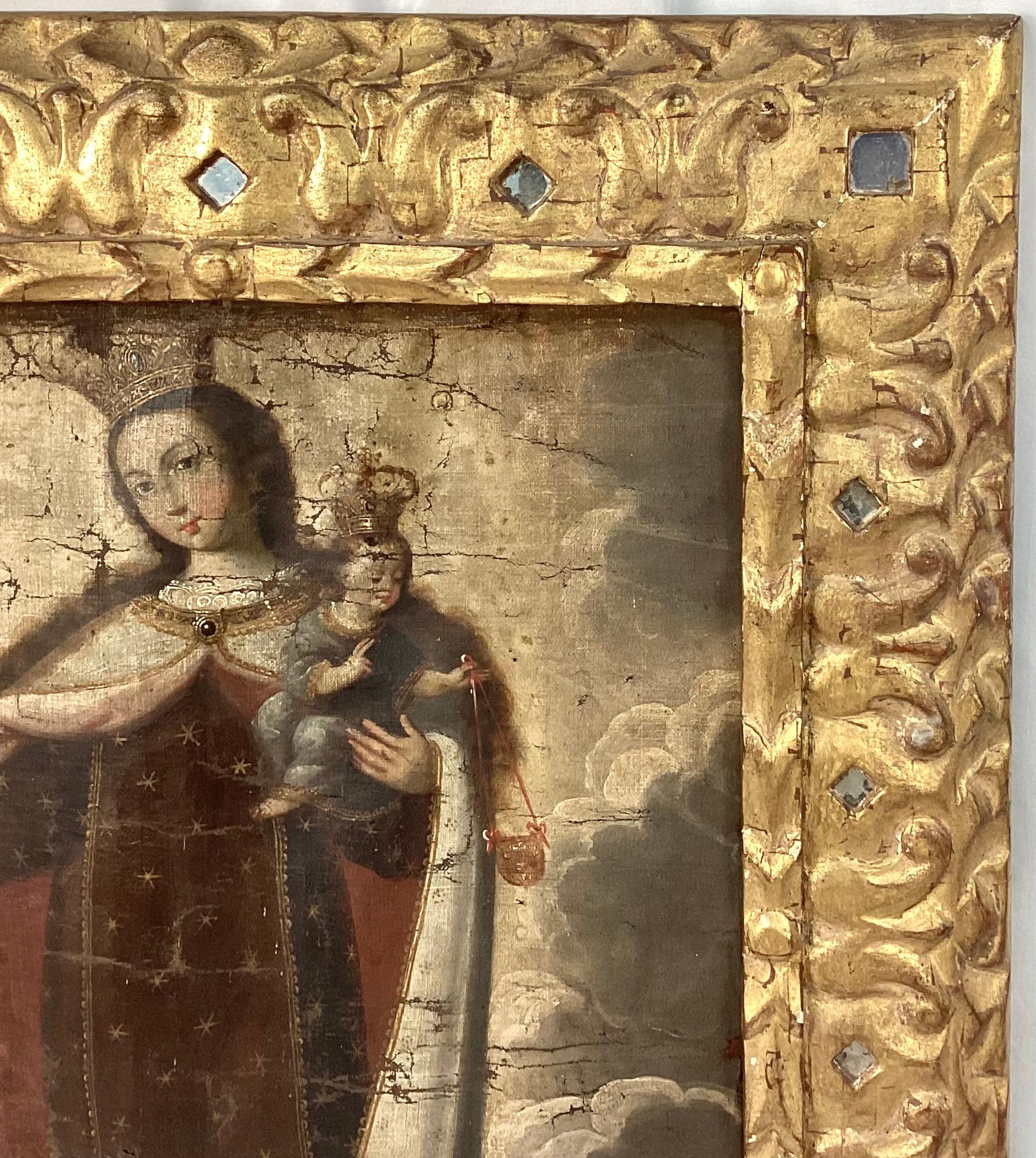 18th century Spanish Colonial oil on canvas painting, mounted on board, in giltwood inlaid with mirror frame. Picture is Our Lady of Mt. Carmel with Christ child, both crowned and holding scapulars.