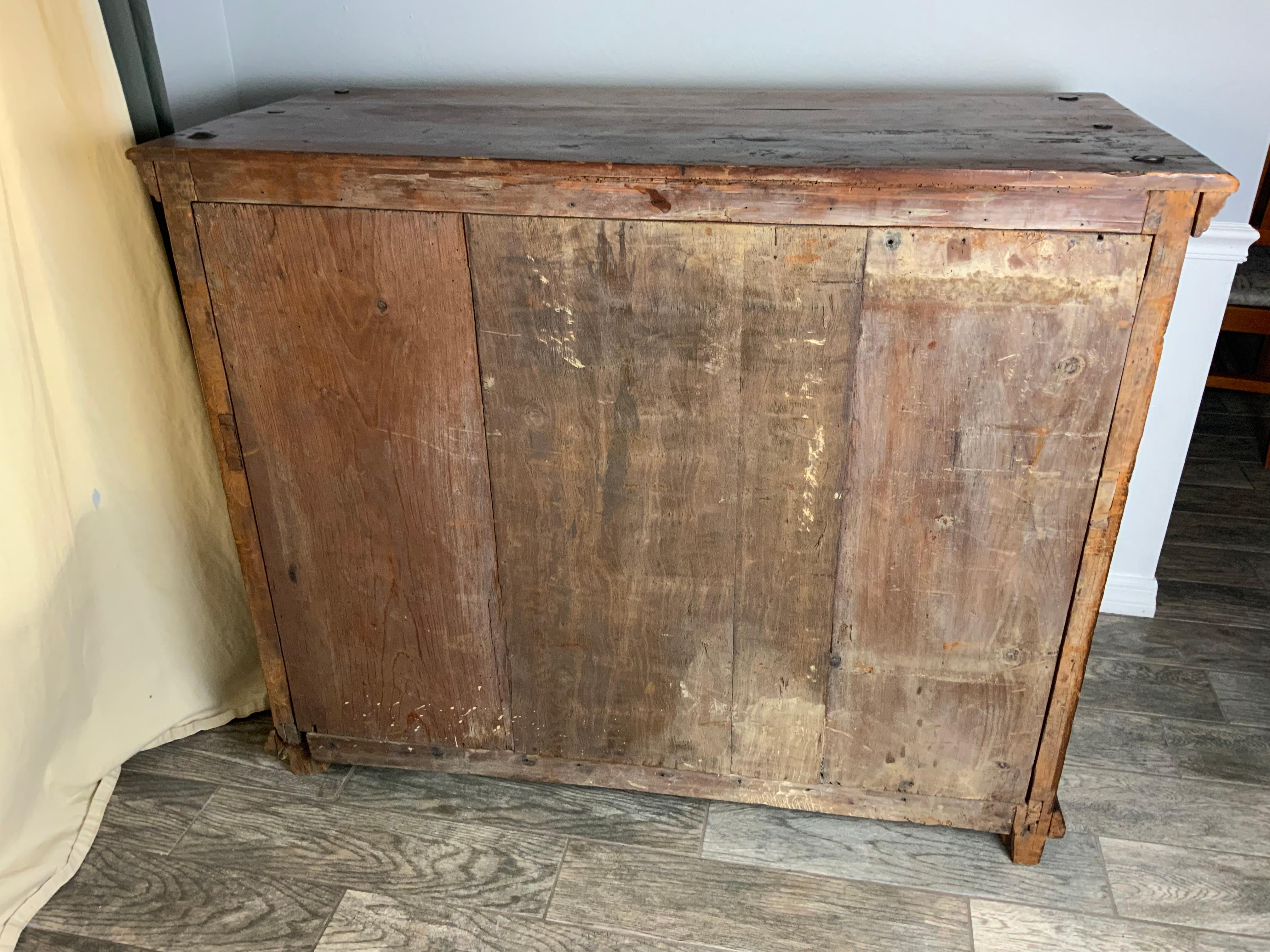 A very nice Spanish Colonial paneled cupboard or cabinet probably mid 18th century Spain constructed of Cedar and Pine.  All paneled construction with clavos trim nails on the top. One original shelf in the interior.  Original hardware and a working