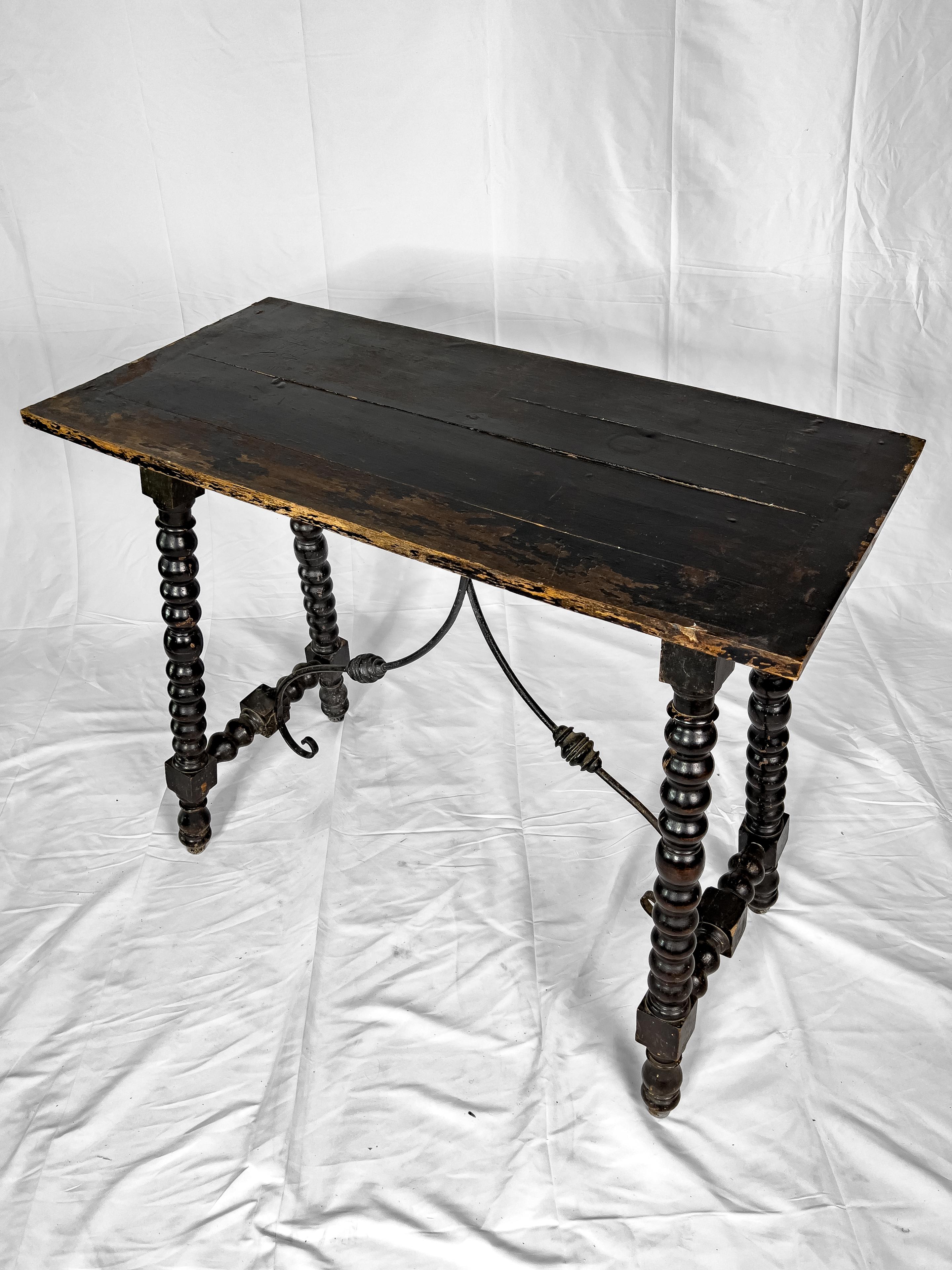 18th century Spanish console table having bobbin turned legs with a shaped iron trestle and a painted finish.