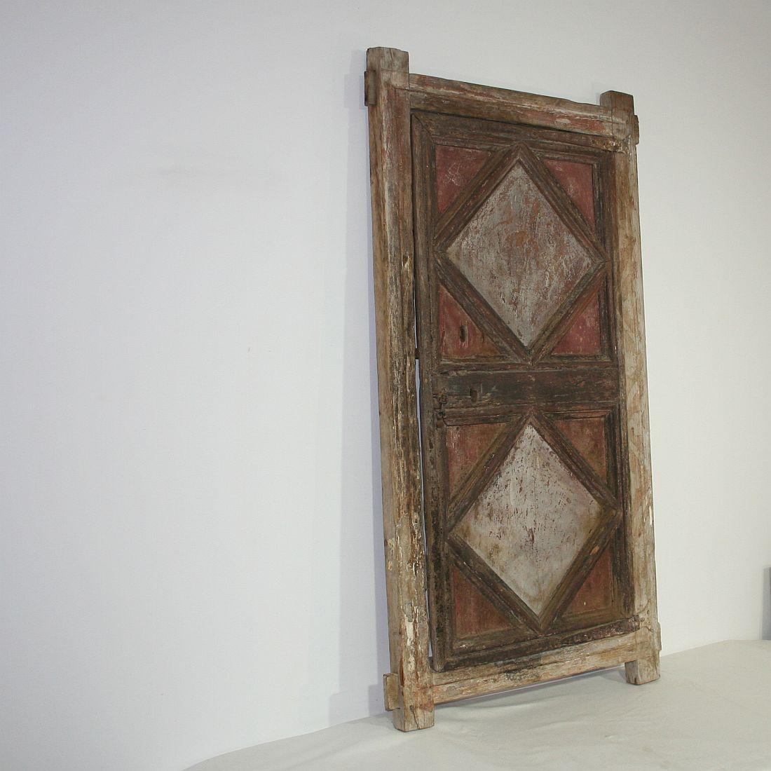Beautiful Spanish cupboard door with traces of its original color. Great decorative statement in a room.
Spain, circa 1750. Weathered. More pictures available on request.