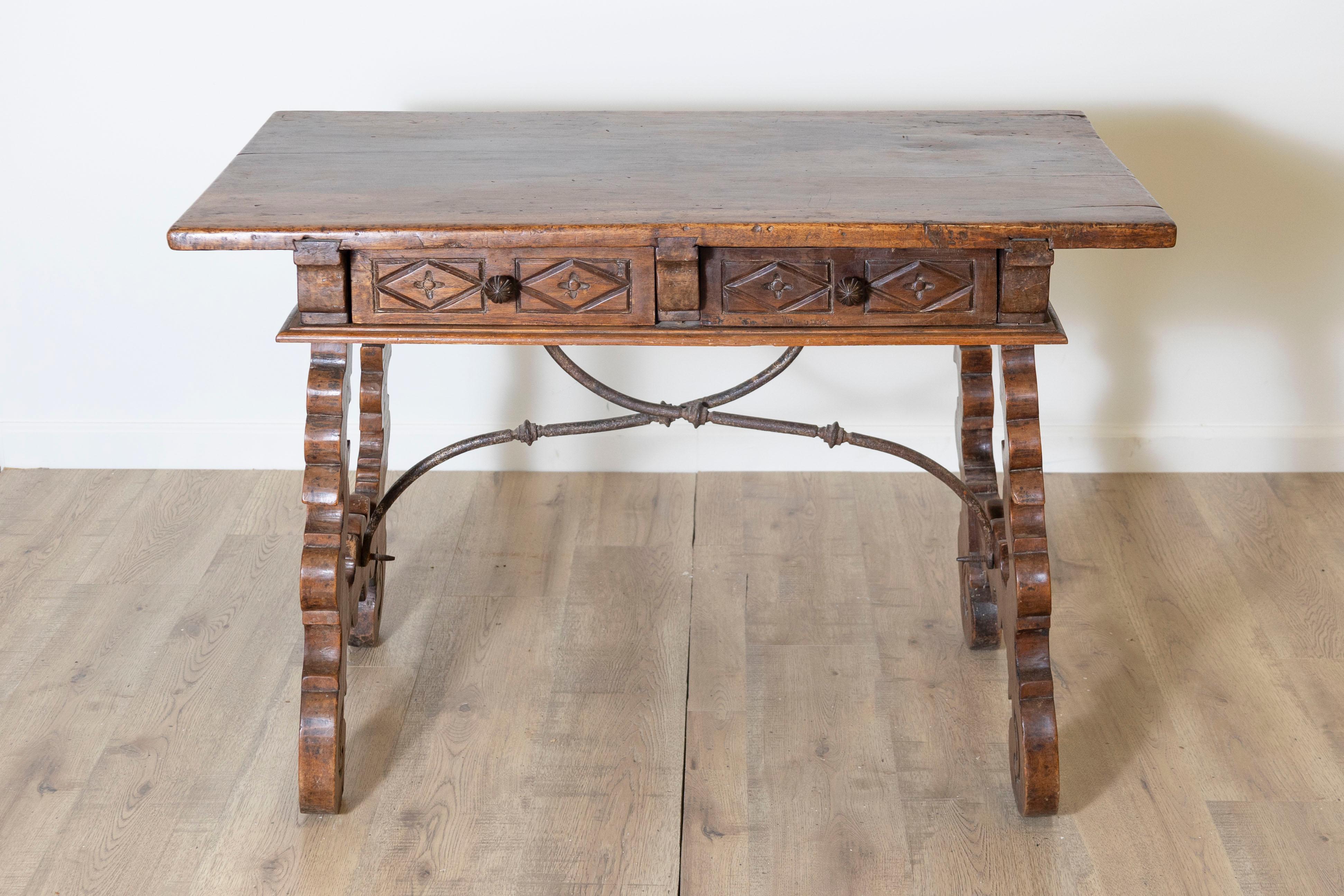 This 18th-century Spanish Fratino table, circa 1790, exemplifies the timeless beauty and craftsmanship of Spanish Renaissance-style furniture. Crafted from solid walnut, the table features a thick rectangular top with a rich, warm patina developed