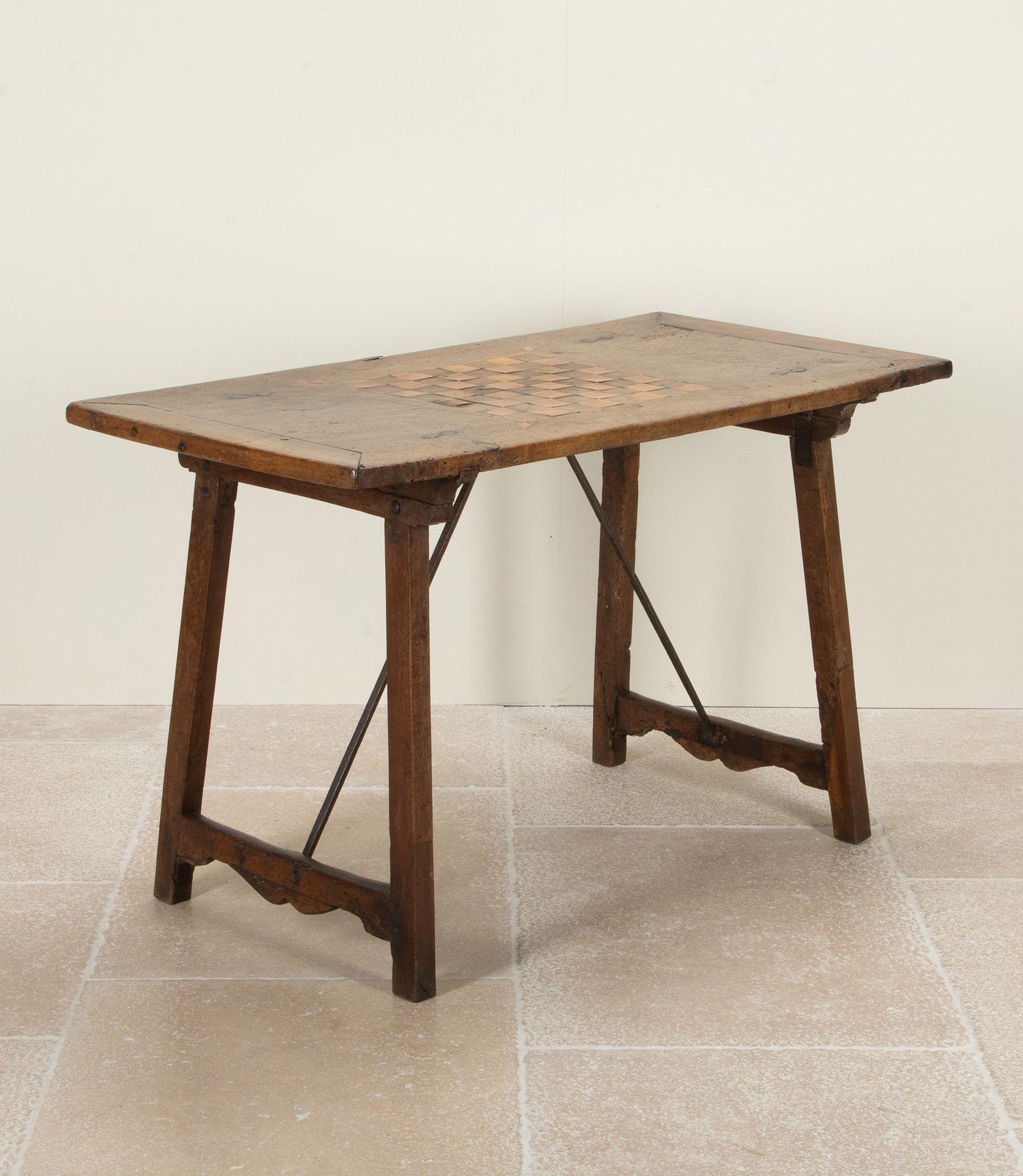 Beautiful 18th Century Spanish games table.
Of mixed wood construction with elegant metal stretchers and folding legs. 
With an inlay games board to the top, displaying a wonderfully primitive aesthetic.