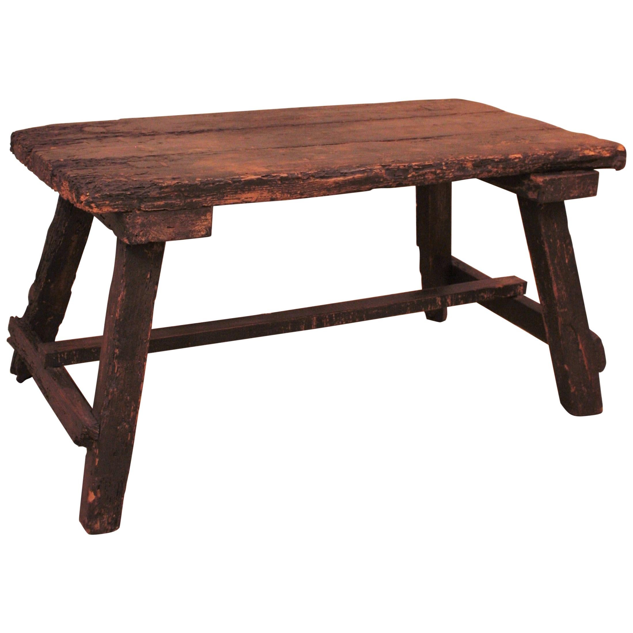 Beautiful primive Spanish pine wood low table.
This table is rustically elegant; it shows beautiful signs of wear and character and all the taste of the ancient Spanish furniture. It can be used as side table, end table or coffee table in a rustic