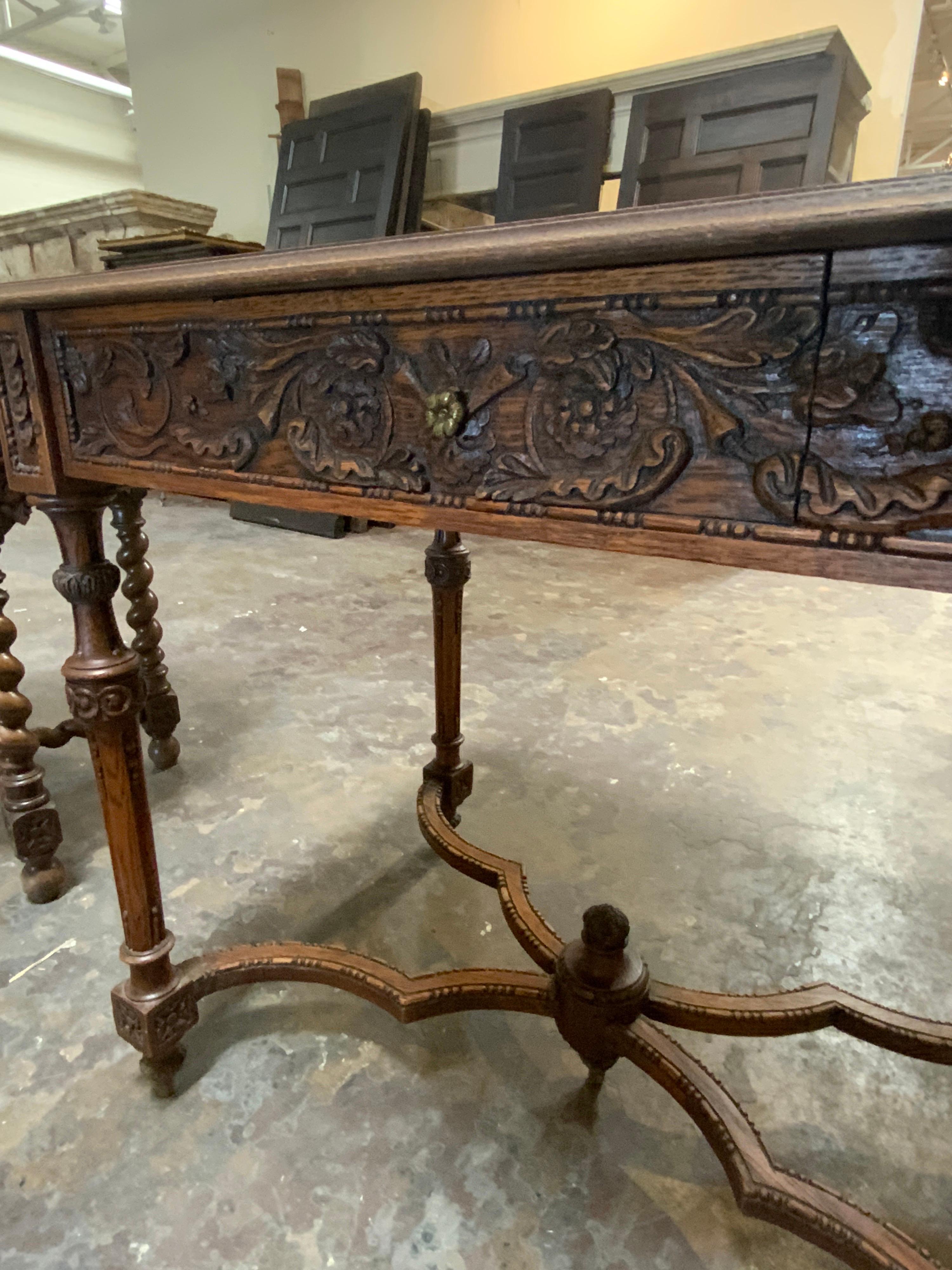 Spanish table made of hand-carved oak wood. Item features front drawer with flower handle. Origin; Spain