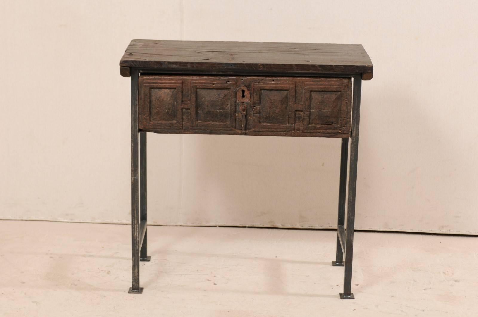 A handsome 18th century Spanish single drawer chest or table. This piece features an 18th century (or earlier) Spanish drawer which has been set into a custom iron base, with an older wood top to produce this fantastic statement piece. The top and