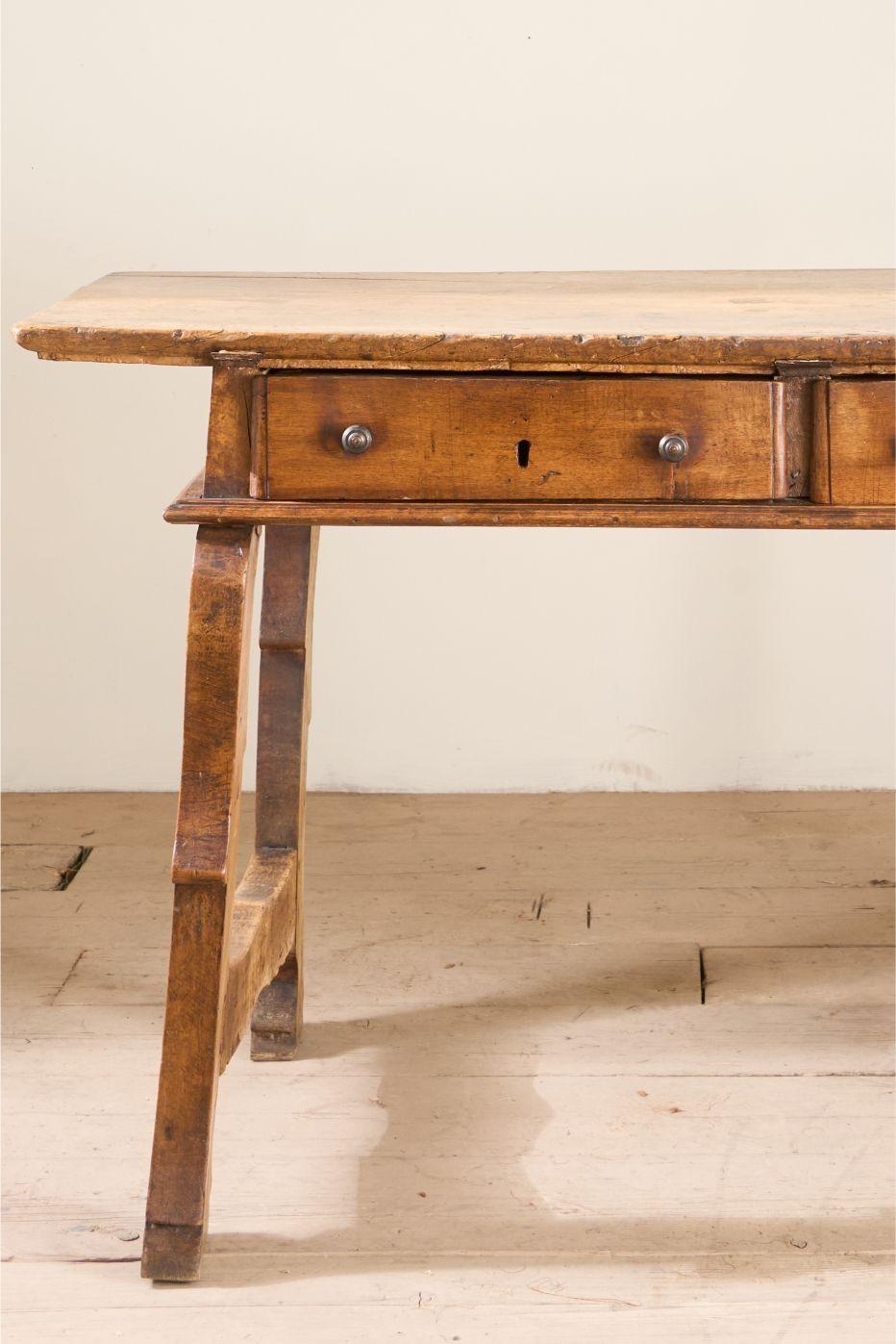 This is a very characterful 18th century Spanish table. It is made from walnut throughout and the top is a stunning single plank that has a wonderful patina and tactile feel that can only be achieved by being a well loved piece of furniture for over