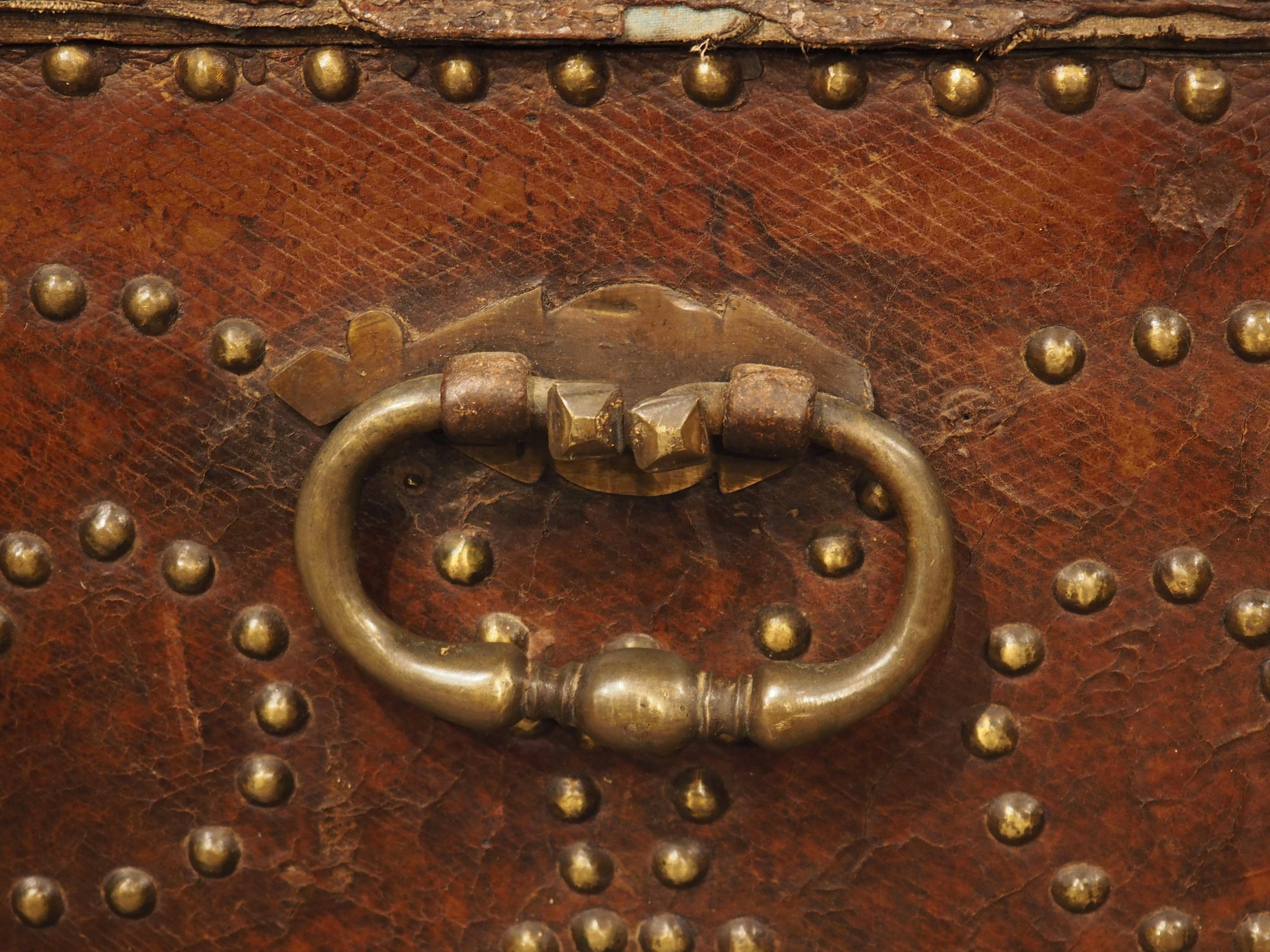 With two lockable compartments on the front façade, this studded leather trunk is a very unique storage piece. Hand-crafted in Spain during the 1700s, the trunk is well-engineered, with adequate storage space in the interior in addition to four