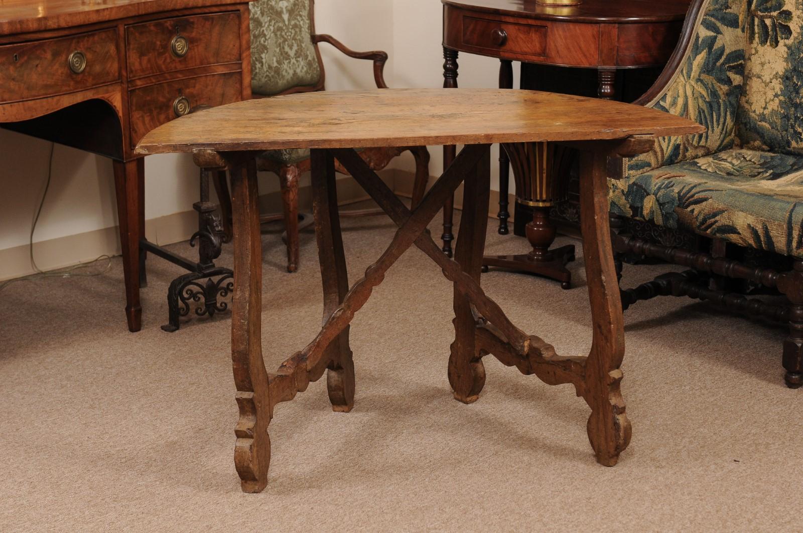 The Spanish walnut demilune table with lyre legs and x-form stretcher.

   