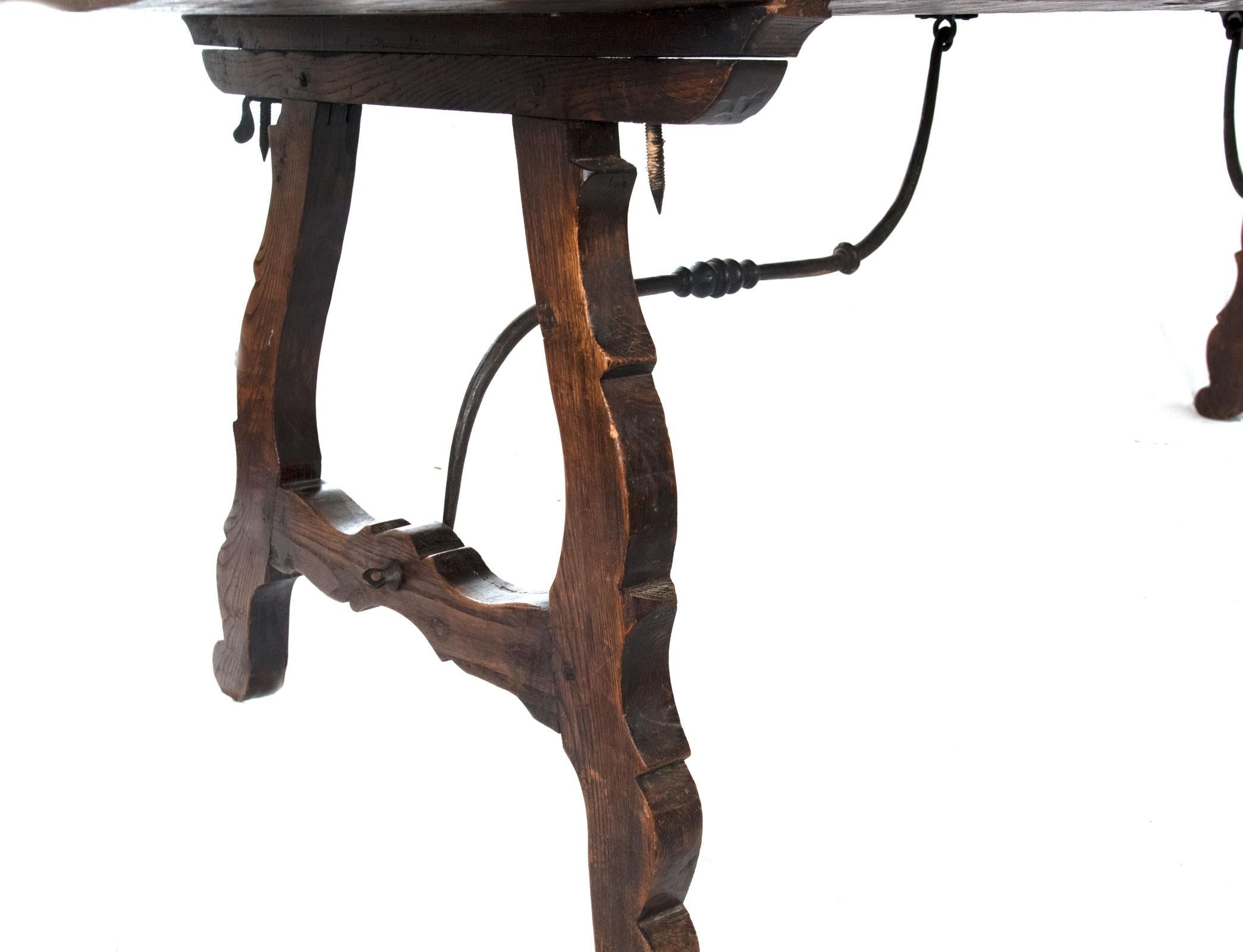 A large, tressle-form table with wrought iron support, dating from the mid-1700s.