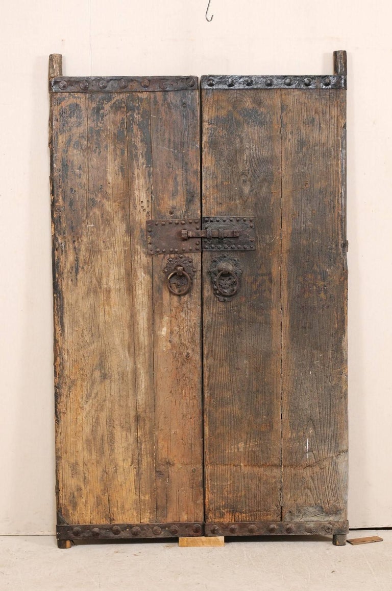 18th Century Spanish Wood Doors With Original Iron Accents And A pair of 18th century Spanish wood doors with wonderful old iron details and hardware. - 18th Century Spanish Wood Doors With Original Iron Accents And