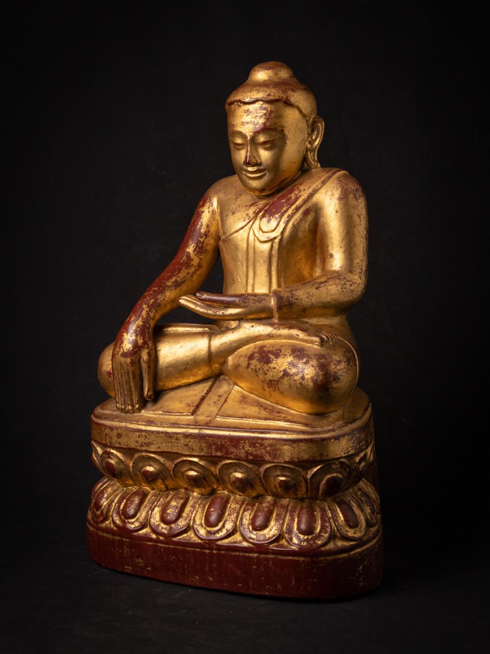 The special antique wooden Burmese Lotus Buddha is a truly extraordinary and sacred artifact originating from Burma. Crafted from wood and adorned with 24-karat gold gilding, this Buddha statue stands at 51 cm in height and measures 31.3 cm in width