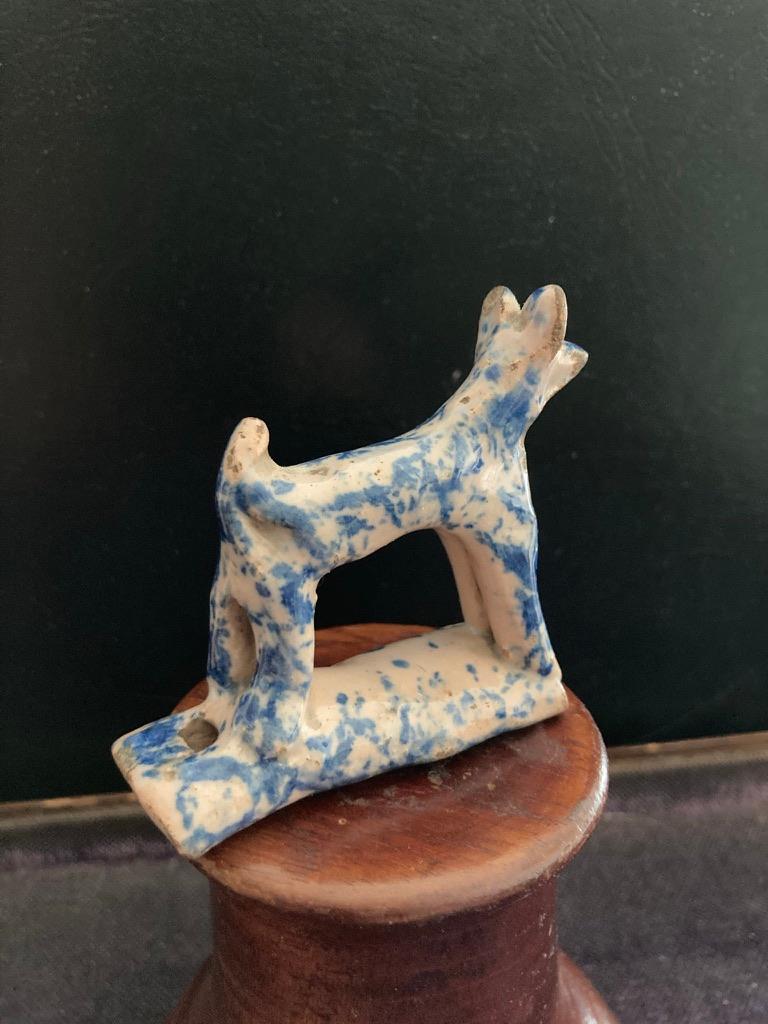 A rare and utterly charming English Staffordshire blue and white glazed ceramic dog whistle. Showing the pooch standing alert with tail up and ears pricked. And it works, definitely gets my dog's attention.