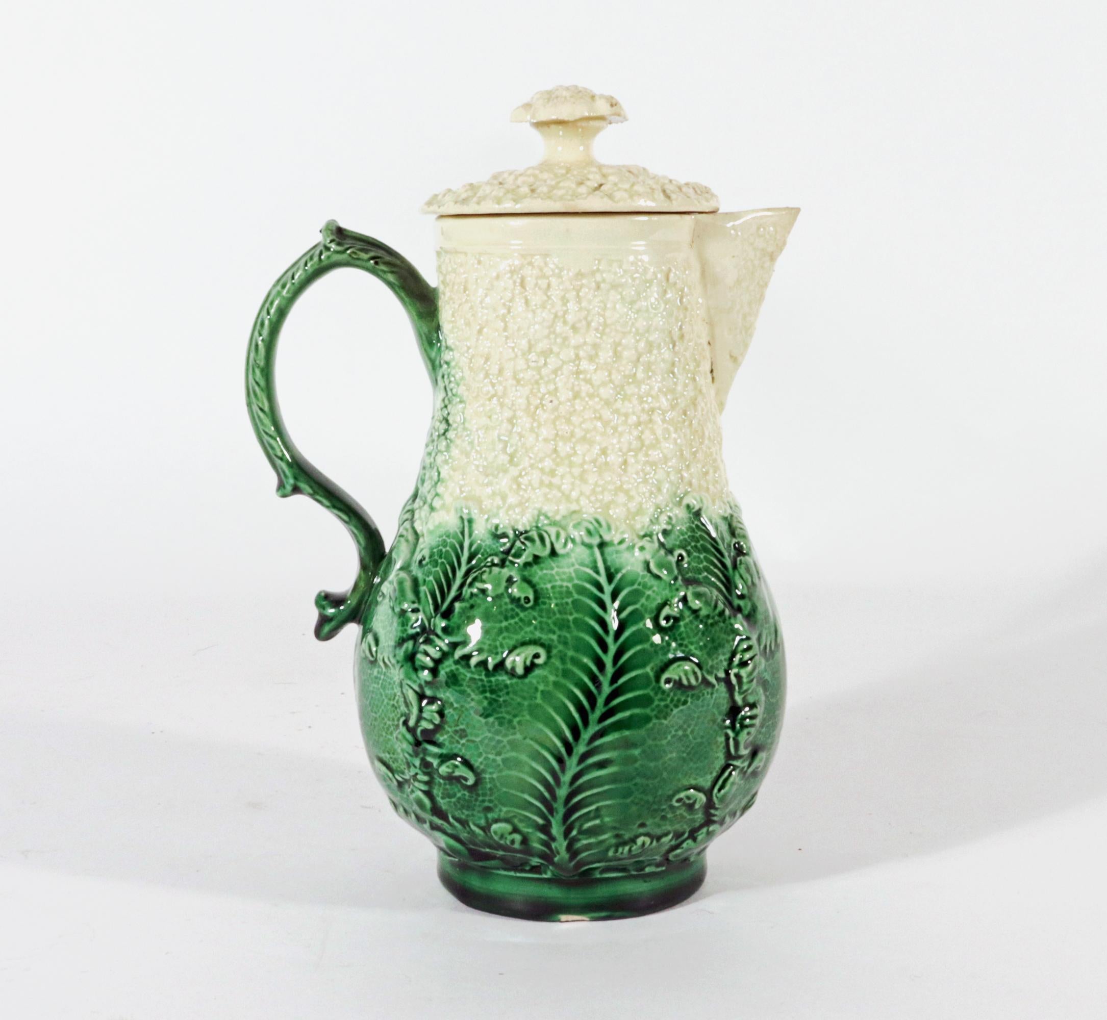 18th Century Staffordshire Creamware Cauliflower Ware Milk Jug and Cover,
Probably by William Greatbach/ Josiah Wedgwood
Lead-glazed earthenware,
Circa 1765

The creamware milk jug  has a baluster-form molded to resemble the leaves and florets of a