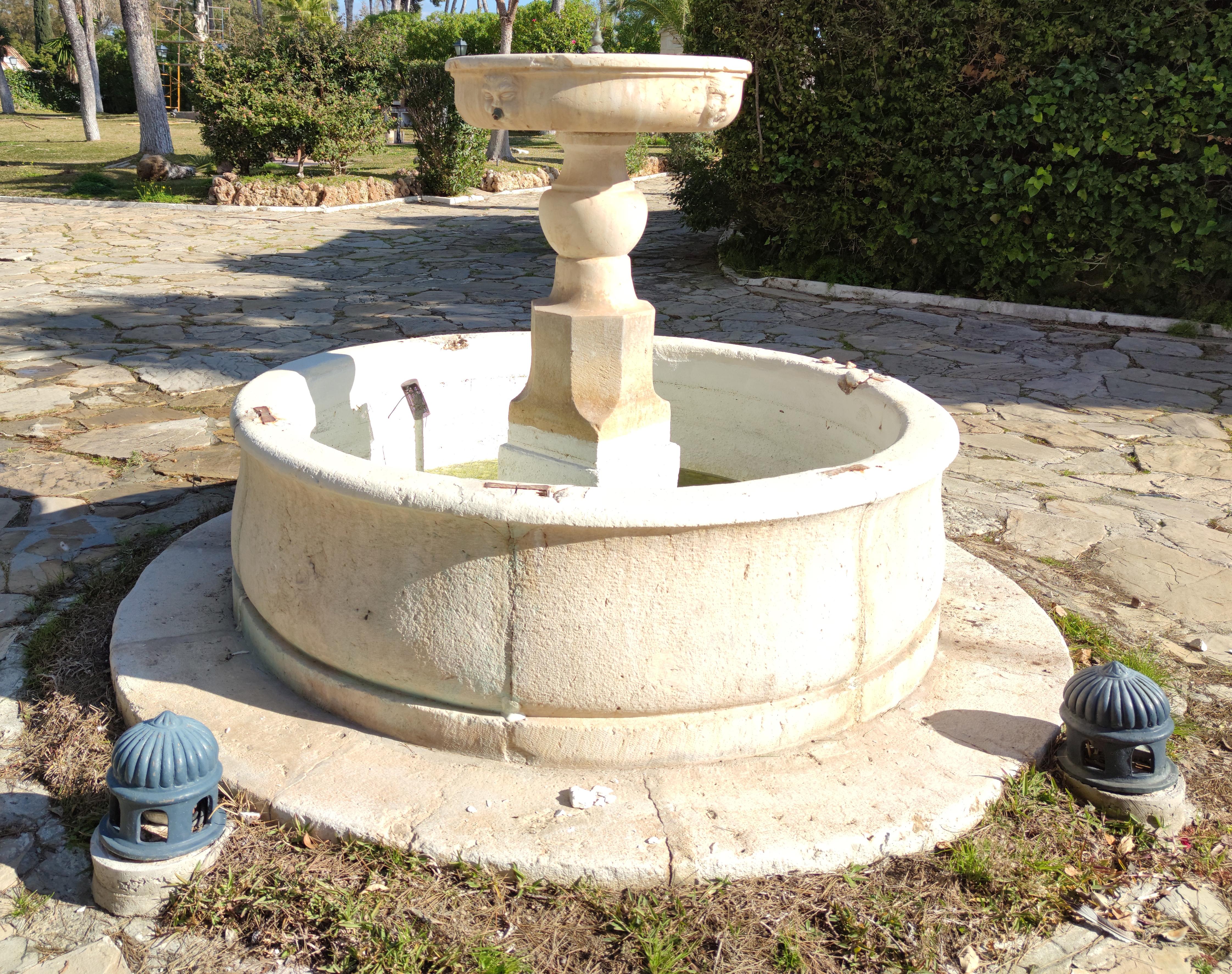 18th century stone fountain and pool surround.