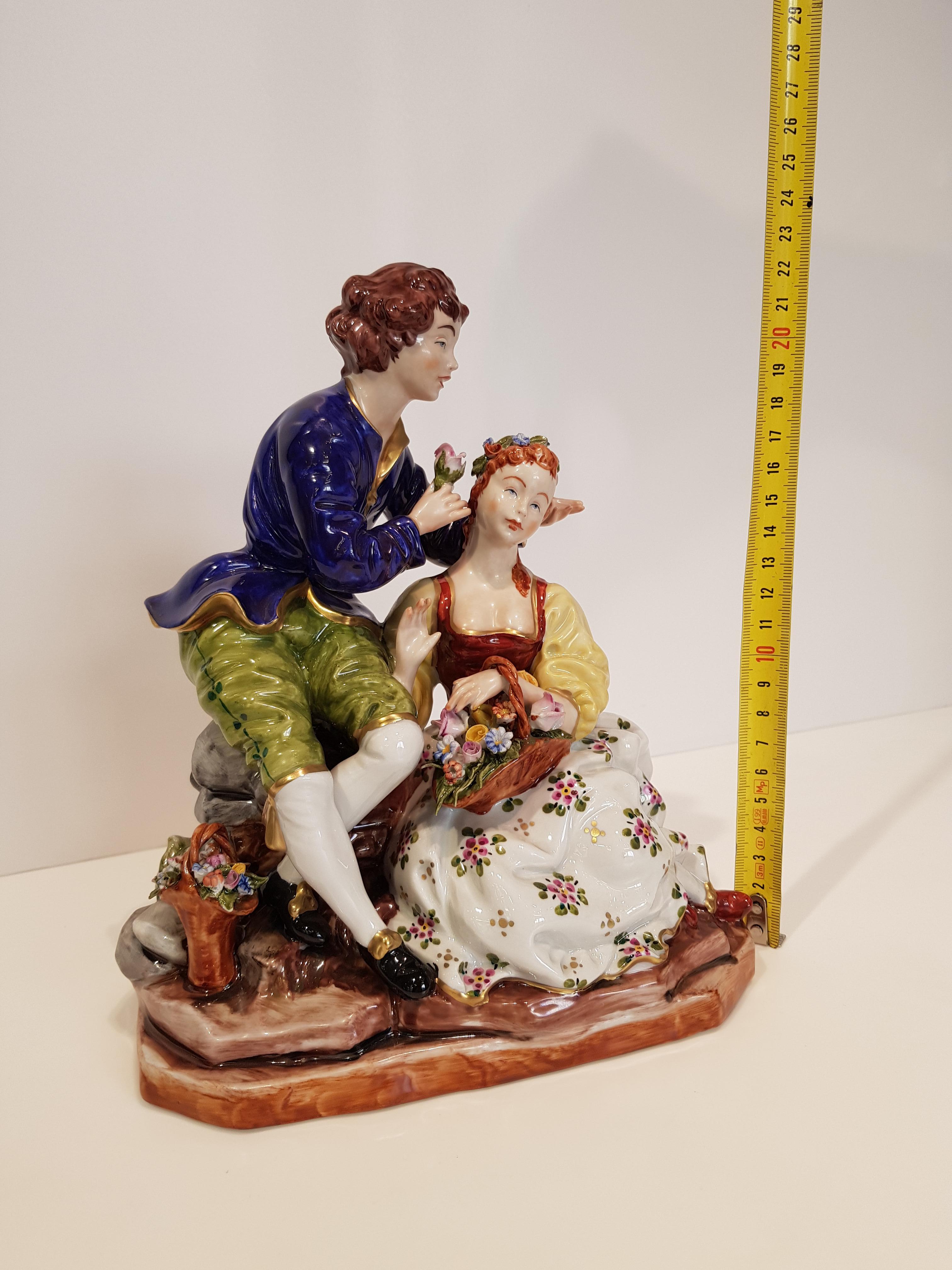 Original italian Capo di Monte porcelain.
This Louis XVI style item represents a romantic scene of a knight willing to gift a flower to a lady of the 18th century, all finely crafted and hand painted with the ancient techniques of the Capo di Monte