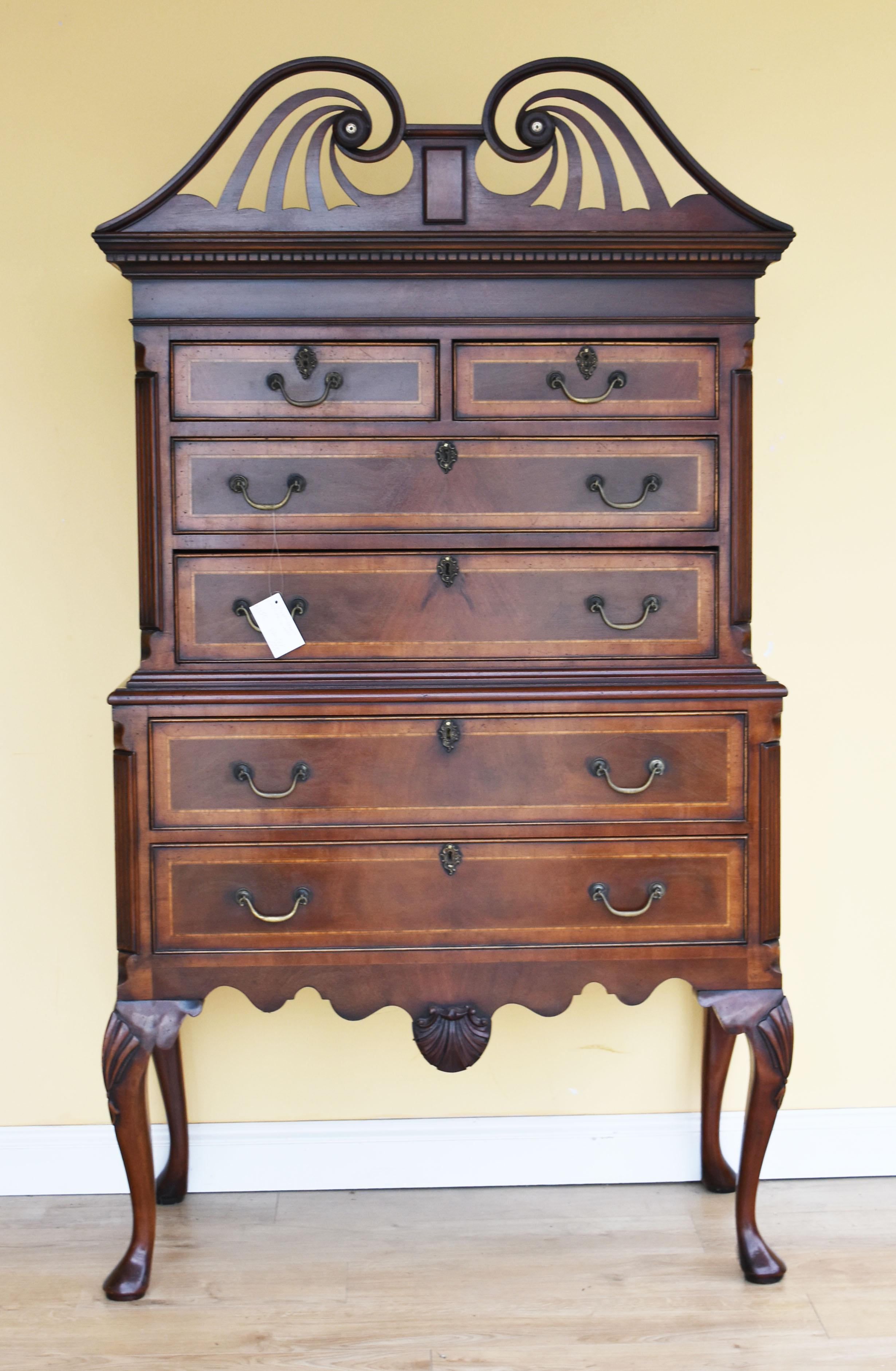 For sale is a good quality Georgian style mahogany chest on stand. The top of the chest has an ornate swan neck pediment above four inlaid and banded drawers, over a further two long drawers in the base below, all flanked by canted corners. The