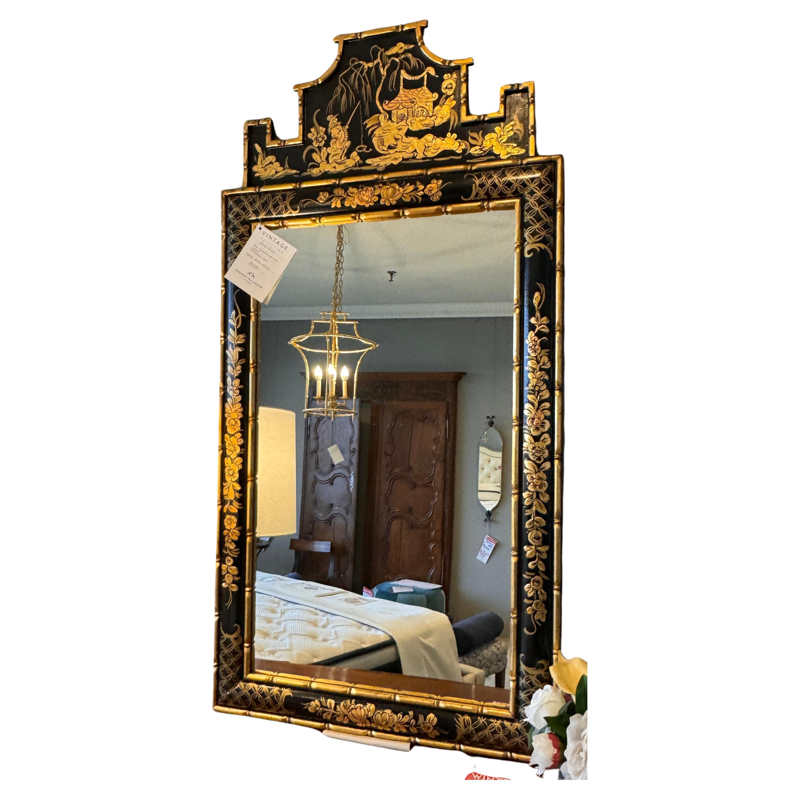 Introducing our exquisite black lacquer mirror, a stunning embodiment of Chippendale elegance infused with captivating chinoiserie details. Crafted with details inspired by traditional Chinese motifs, creating a mesmerizing fusion of