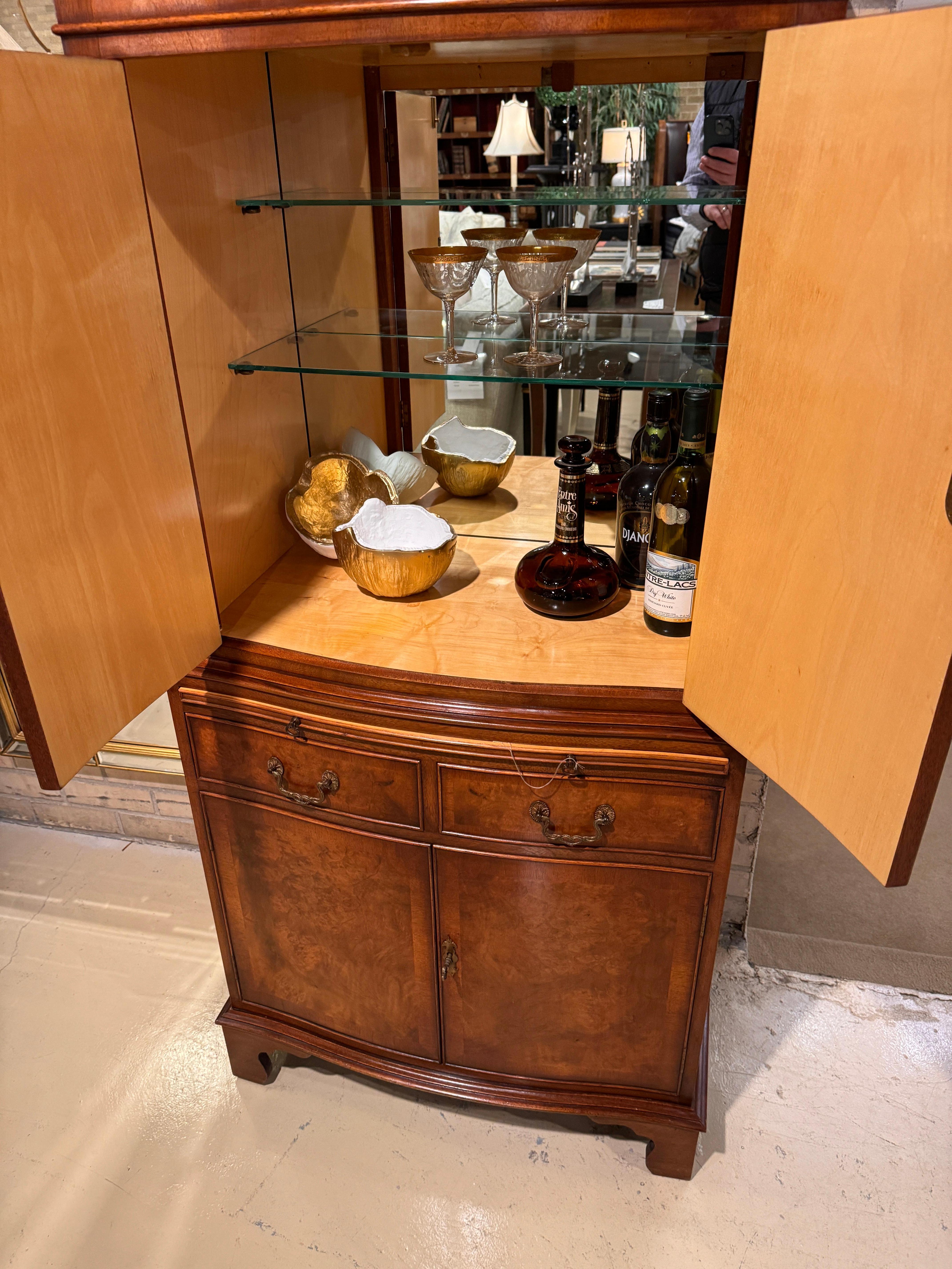 This is an absolutely fantastic example of an 18th Century Style drinks cabinet or dry bar crafted in England with meticulous attention to detail.  The cabinet is in Walnut solids and veneer and a showstopper of Burr Walnut veneers on the door and