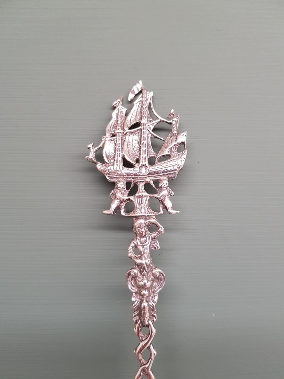 Dutch silver spoon decorated in 18th century style with on top a ship and landscape in the spoon, marked with lion and the letter V 