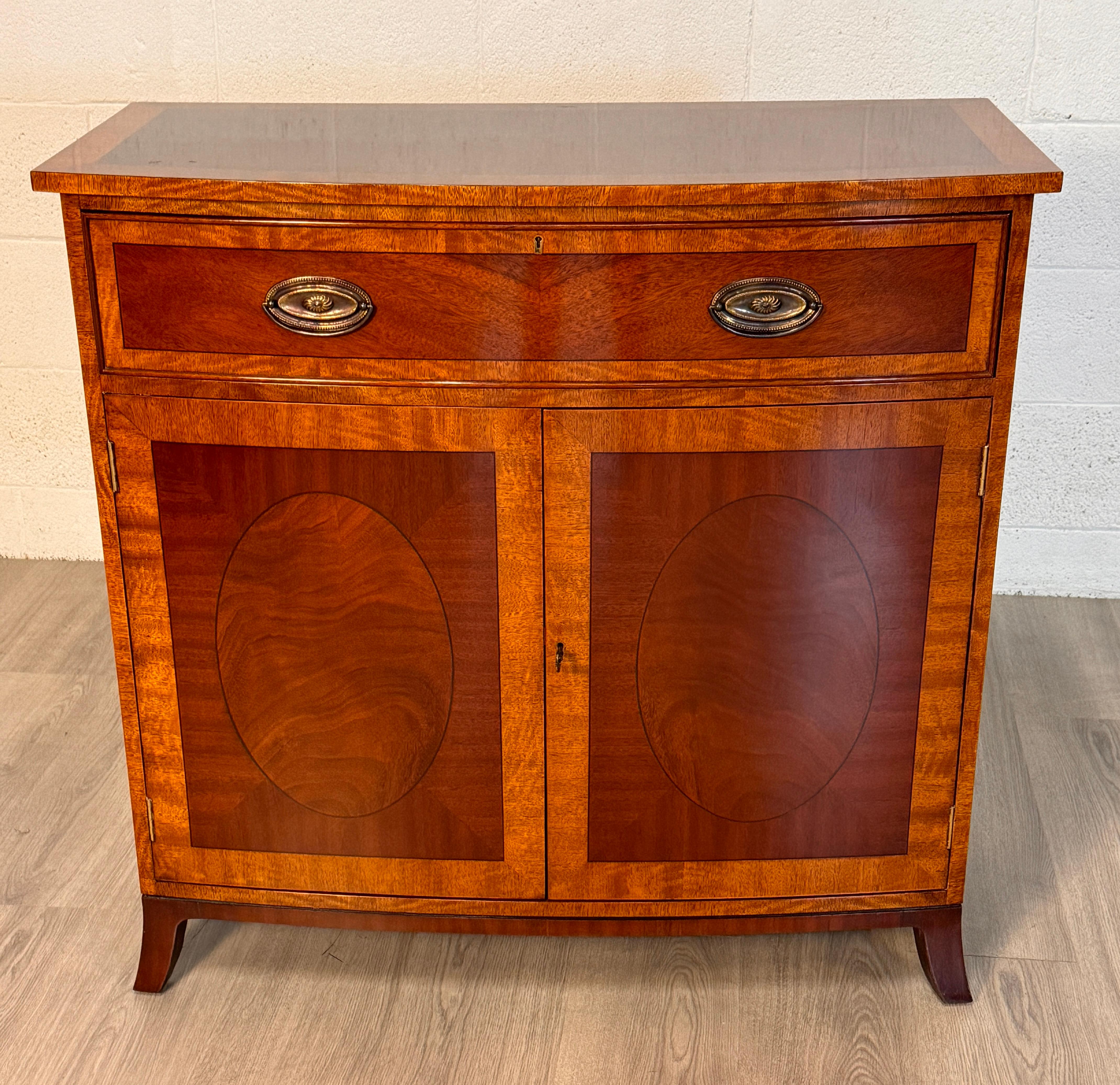 presenting an 18th Century Style English Banded Server / Buffet in a classic design crafted in mahogany with a beautiful mahogany cross band on the front as well as the sides.  Lots of valuable storage with the large drawer for linens, made with the