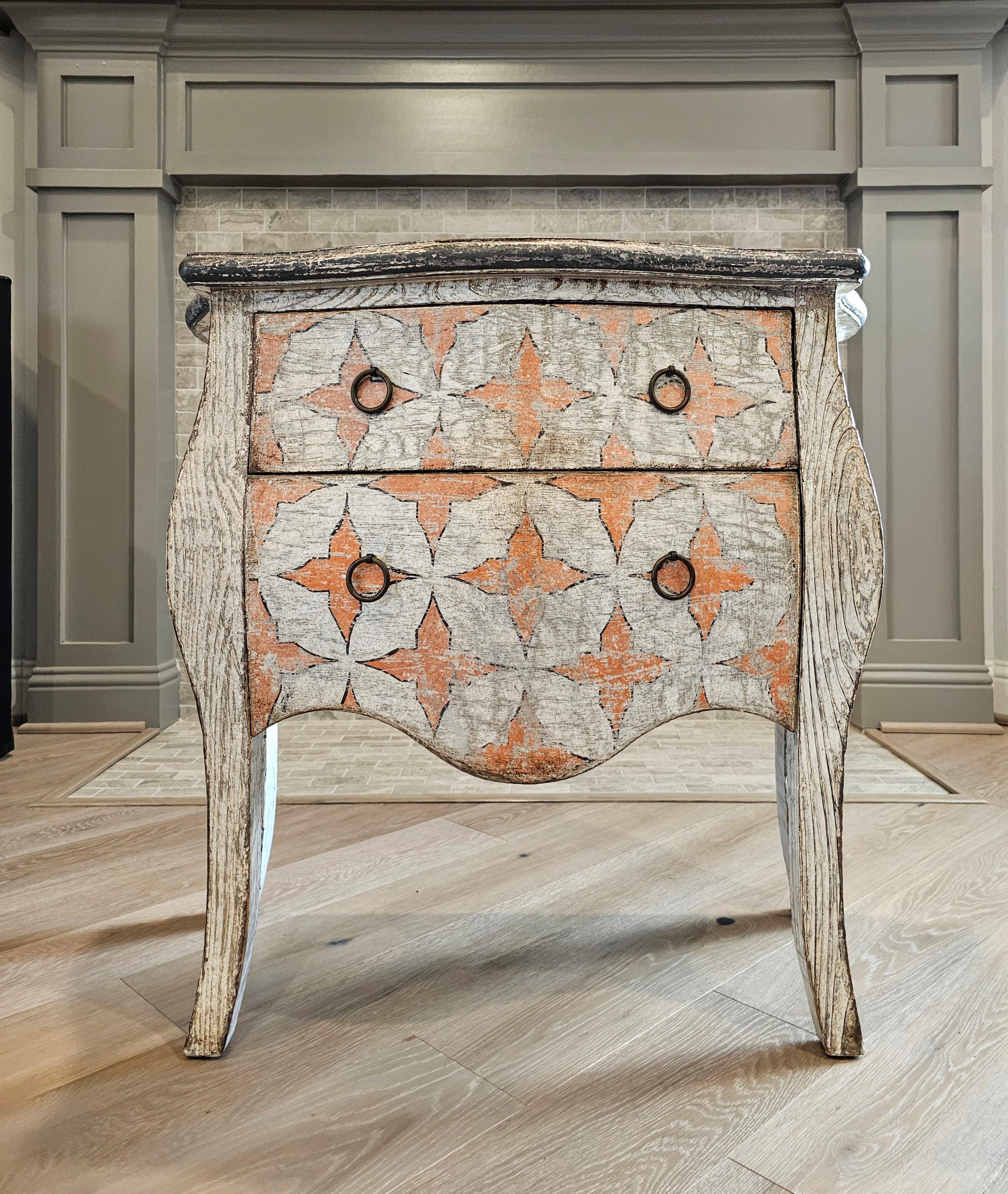 A visually striking vintage French Louis XV style painted whitewashed cerused oak petite bombé chest of drawers (bedside nightstand - small commode dresser - chair side cabinet - end table - hall console) with charming heavily distressed antiqued