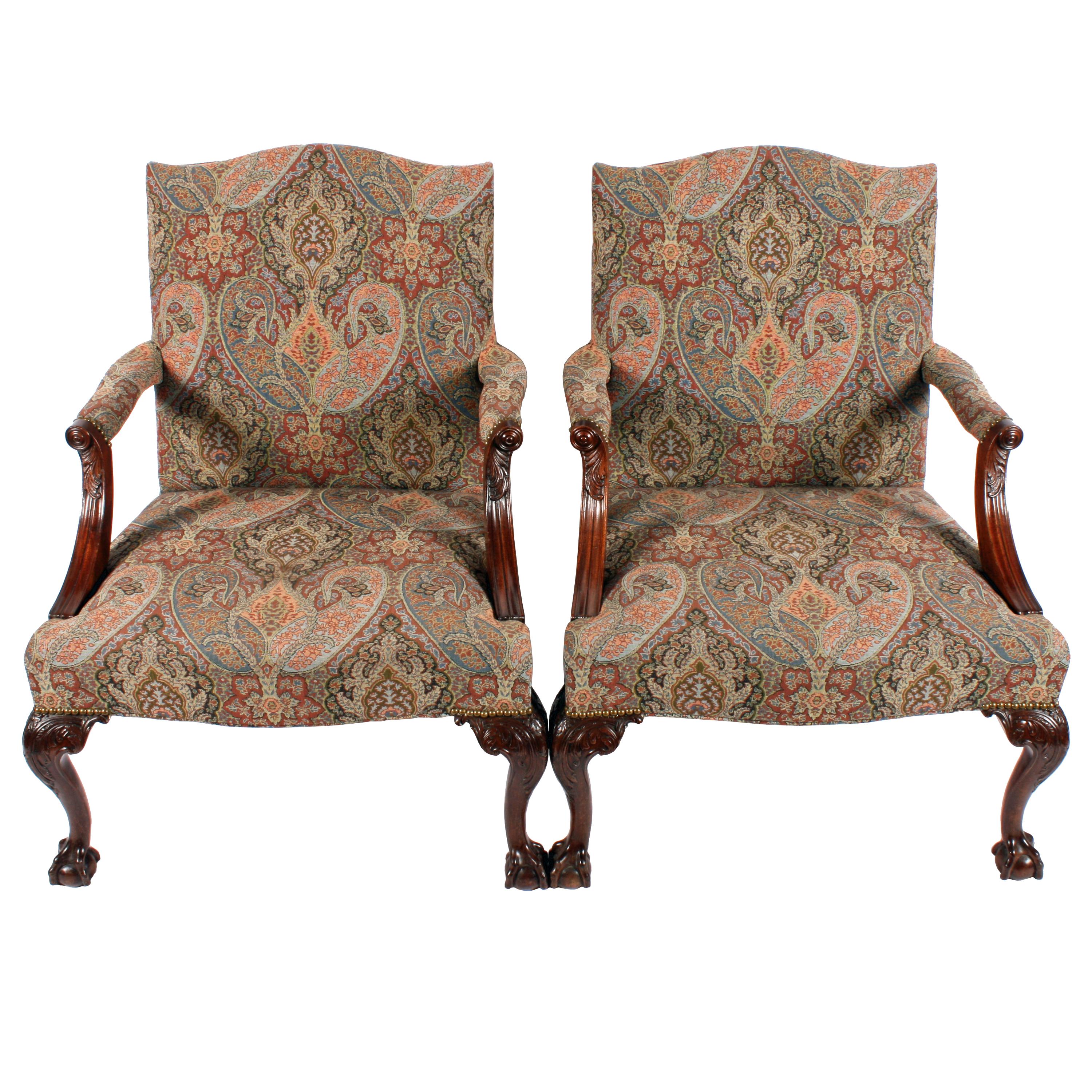A pair of 18th century style mahogany Gainsborough arm chairs.

These Chippendale style chairs are large with cabriole front legs that have carved acanthus knees and carved claw and ball feet.

The back legs are cabriole shaped and have a pad