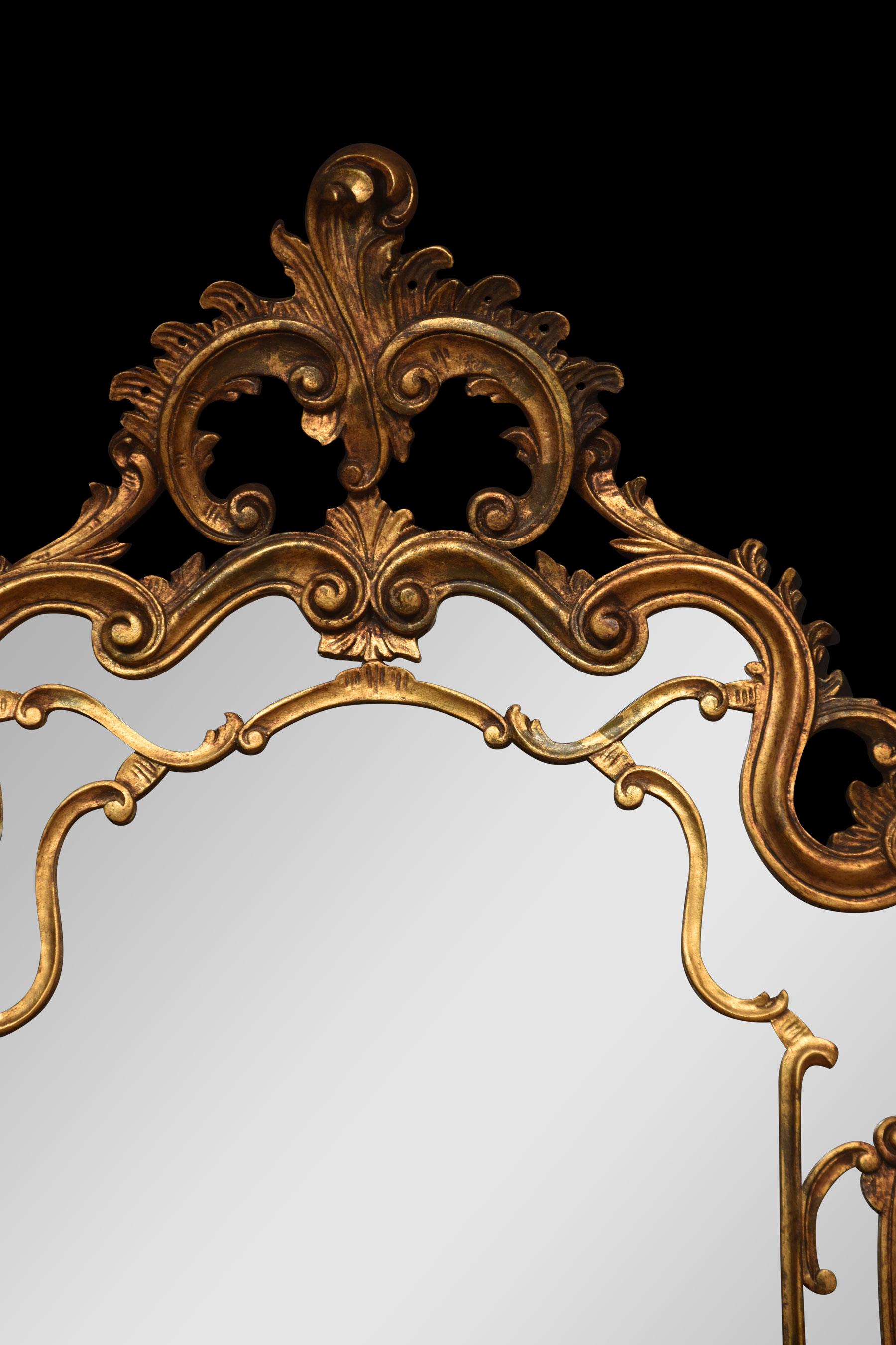 18th century style giltwood wall mirror with elaborate scrolling and foliate mounted frame encasing the original mirror plate.
Dimensions
Height 60 Inches
Width 37.5 Inches
Depth 6 Inches.