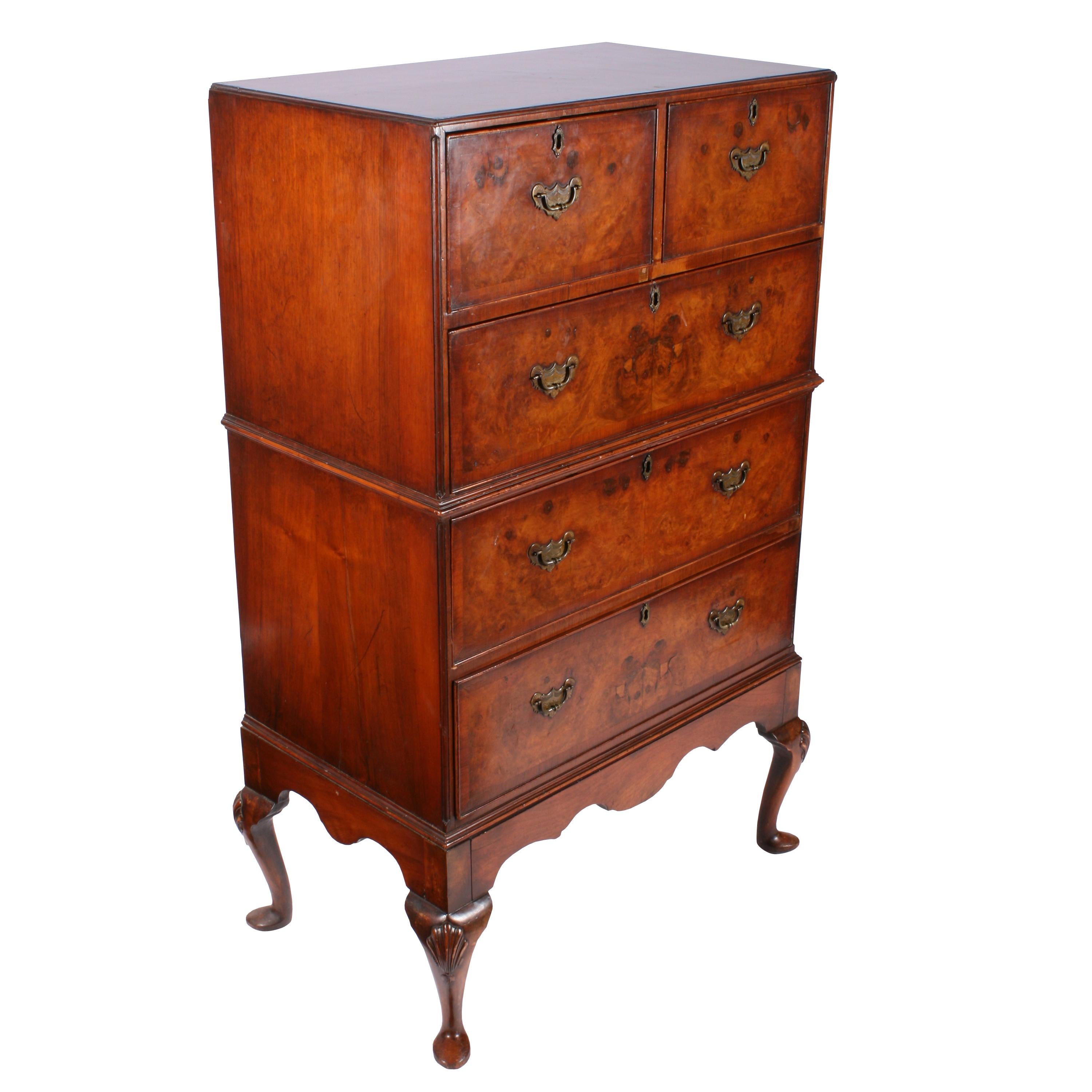 A late 19th-early 20th century walnut chest on stand.

This 18th century style chest has cabriole legs with carved shells on the knees.

The chest has two shortdrawers over three graduated long drawers with a shaped moulding half way up.

The