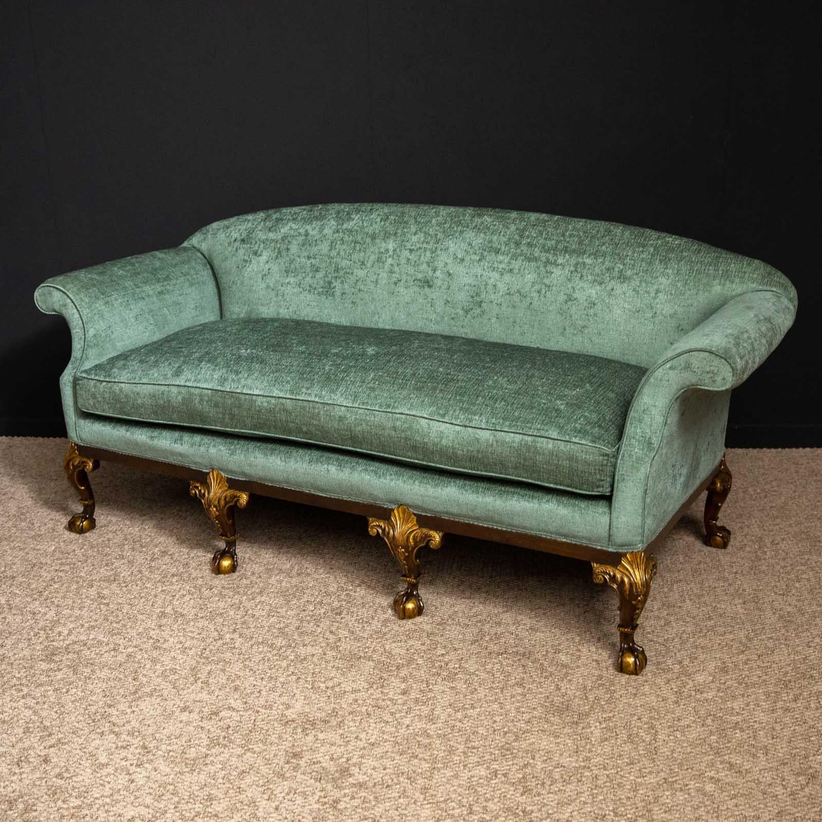 An extremely elegant sofa from the 1920s. The finely carved mid-18th century style legs are solid walnut with parcel gilt highlights. The upholstery is new and of a silky looking green chenille. A super quality piece that looks quite stunning.
  