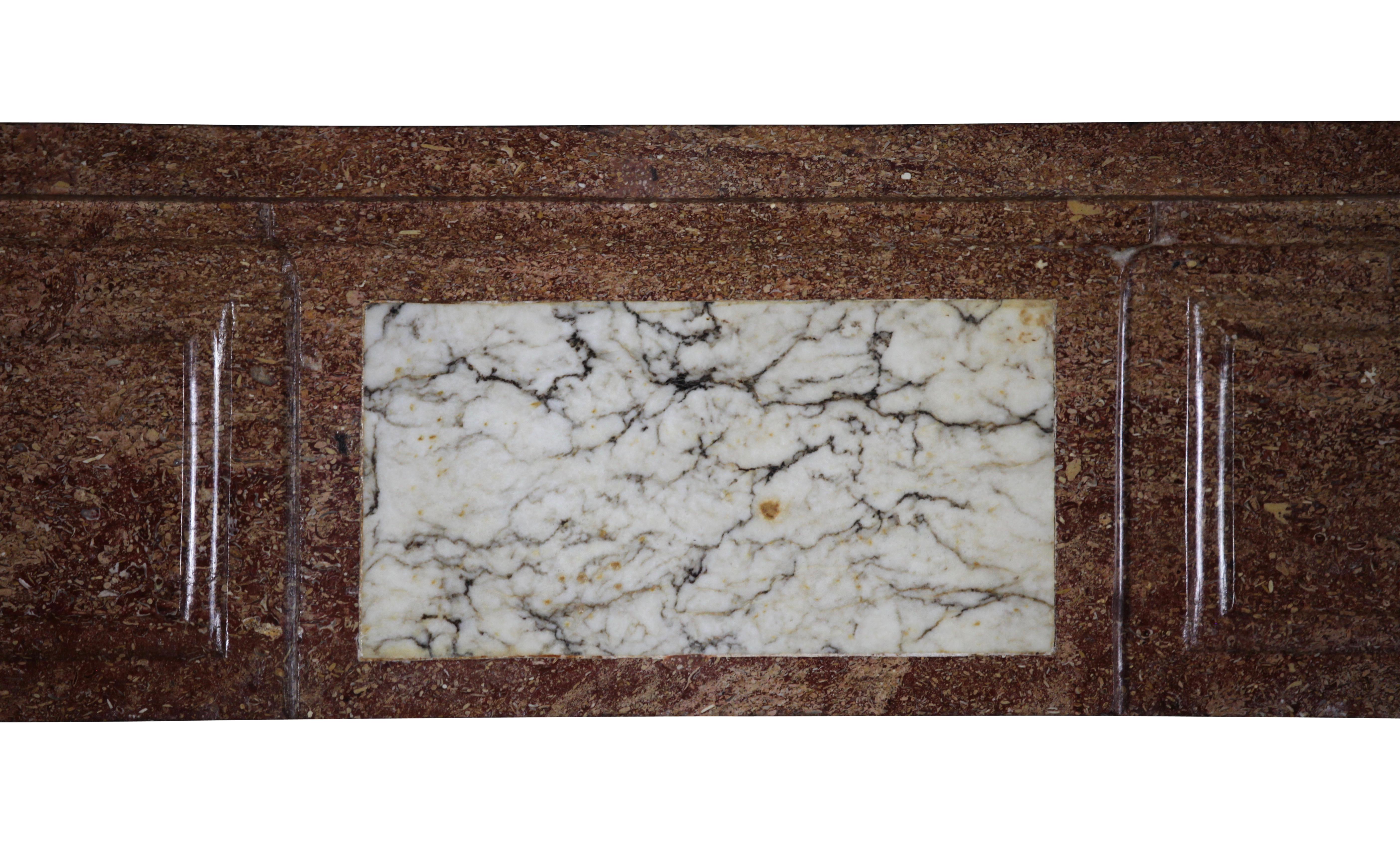 This burgundy hardstone vintage fireplace surround with some Carrara marble inlay can work great in a Italian style or French style interior. Warm of color and unusual. It is Louis XVI period.

Measures:
154.5 cm EW 60.83