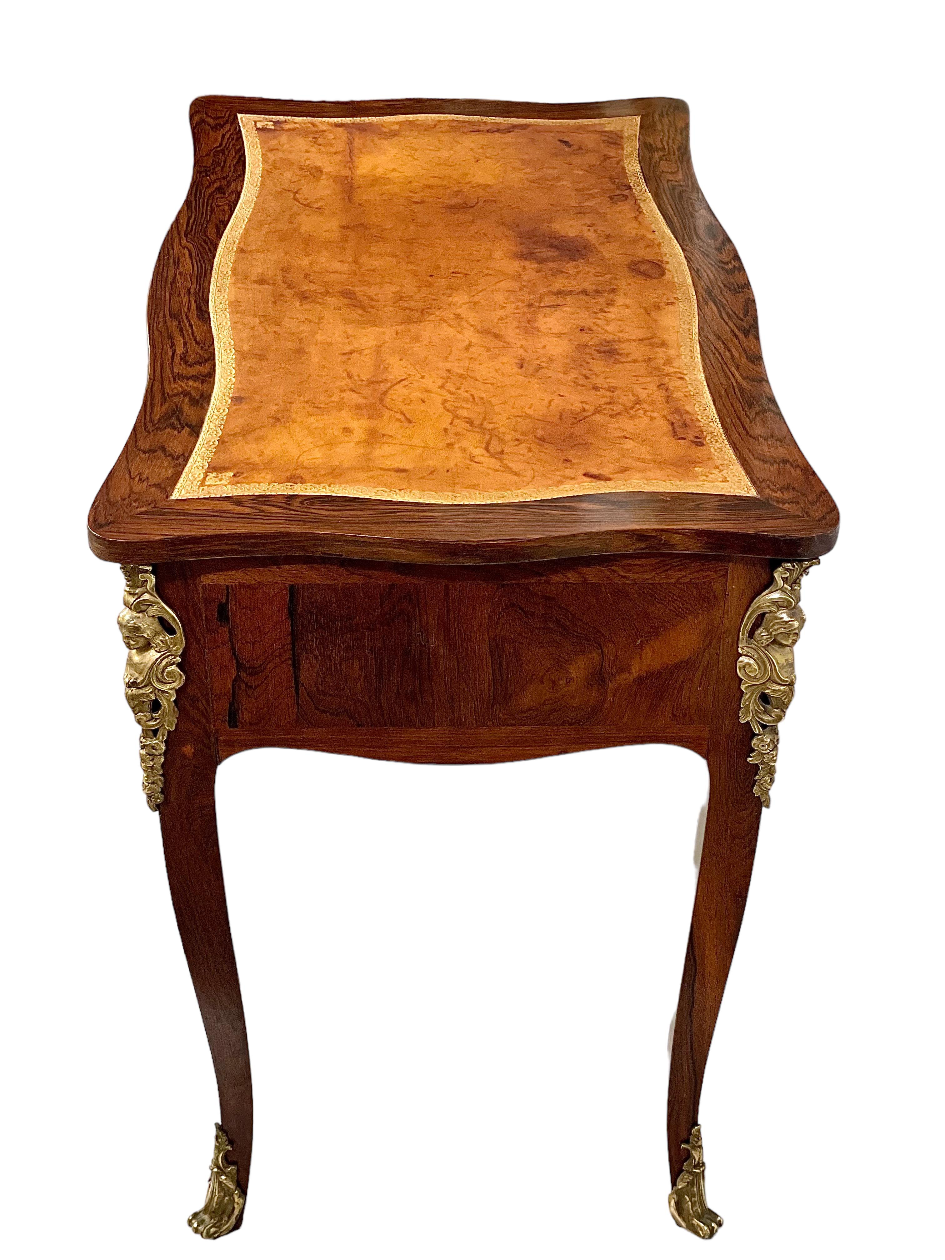 Datant de la période Louis XV, cette exquise petite table à écrire porte le poinçon de Delorme (Adrien Delorme, reçu Maître le 22/06/1748). Faisant office de table à écrire ou de bureau de dame, il présente une marqueterie et dévoile une triade de
